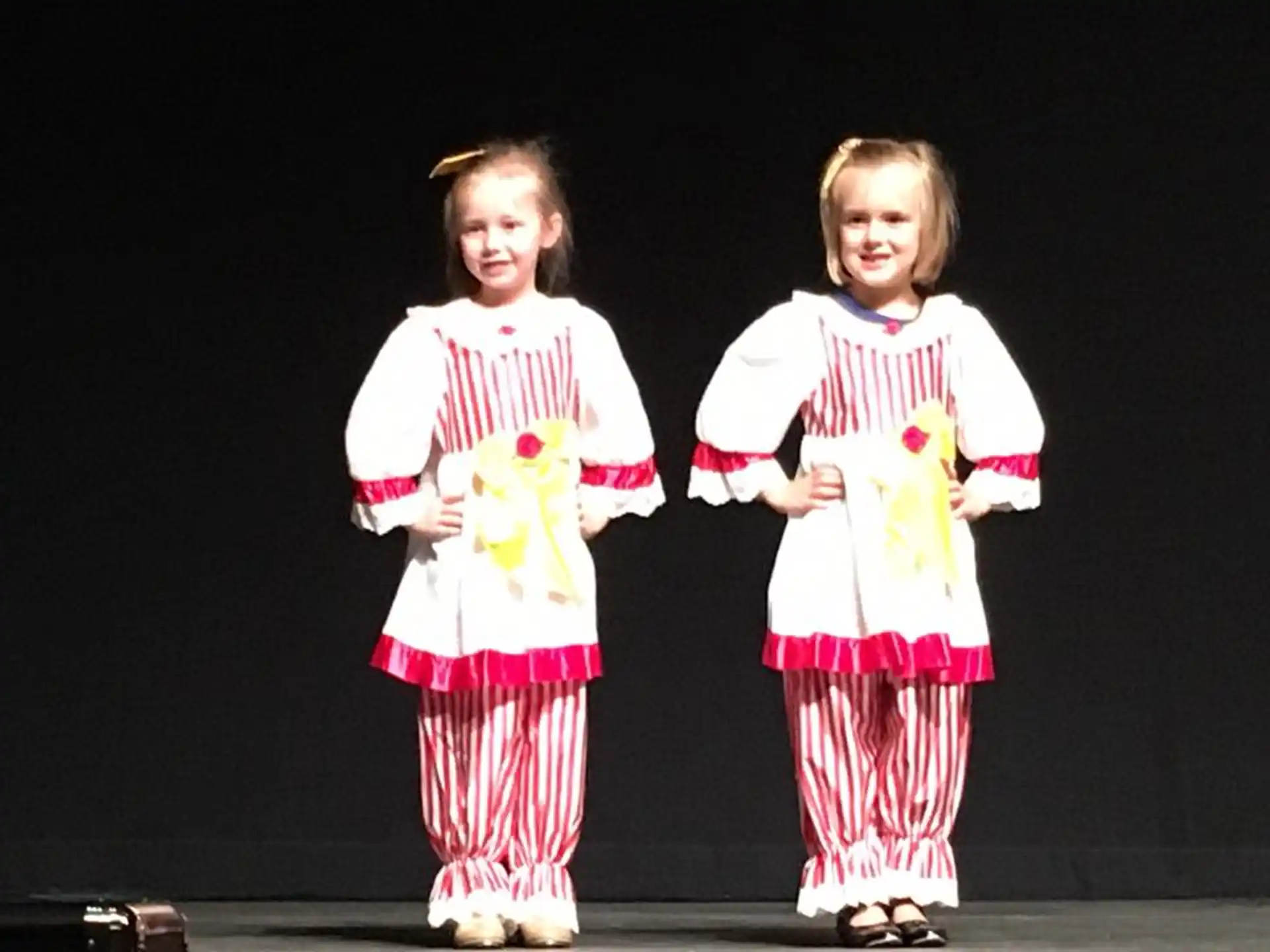 two girls wearing matching outfits