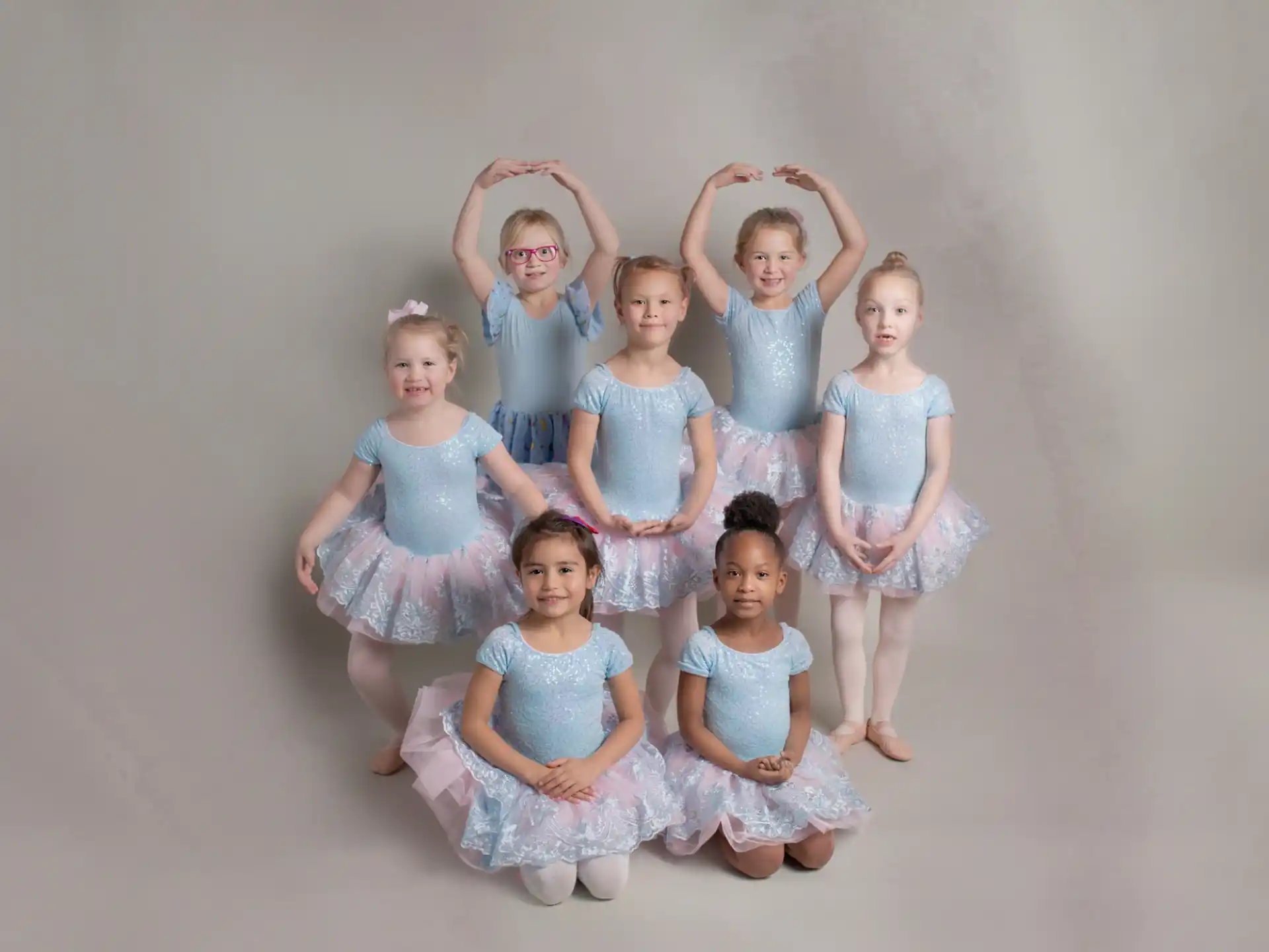 a group of girls in dresses