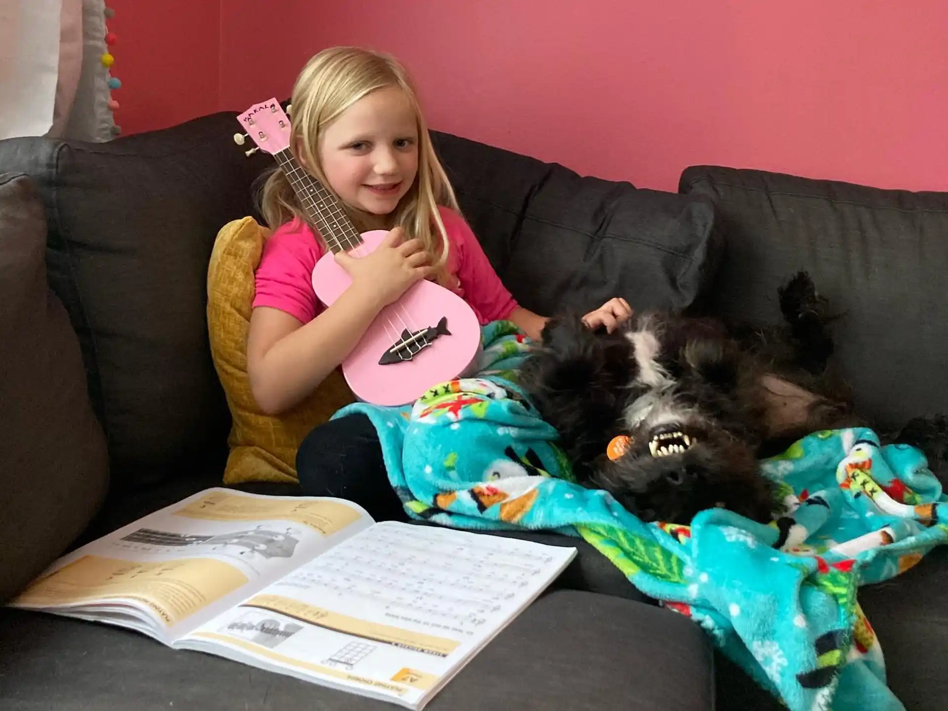a girl sitting on a couch with a cat on her lap