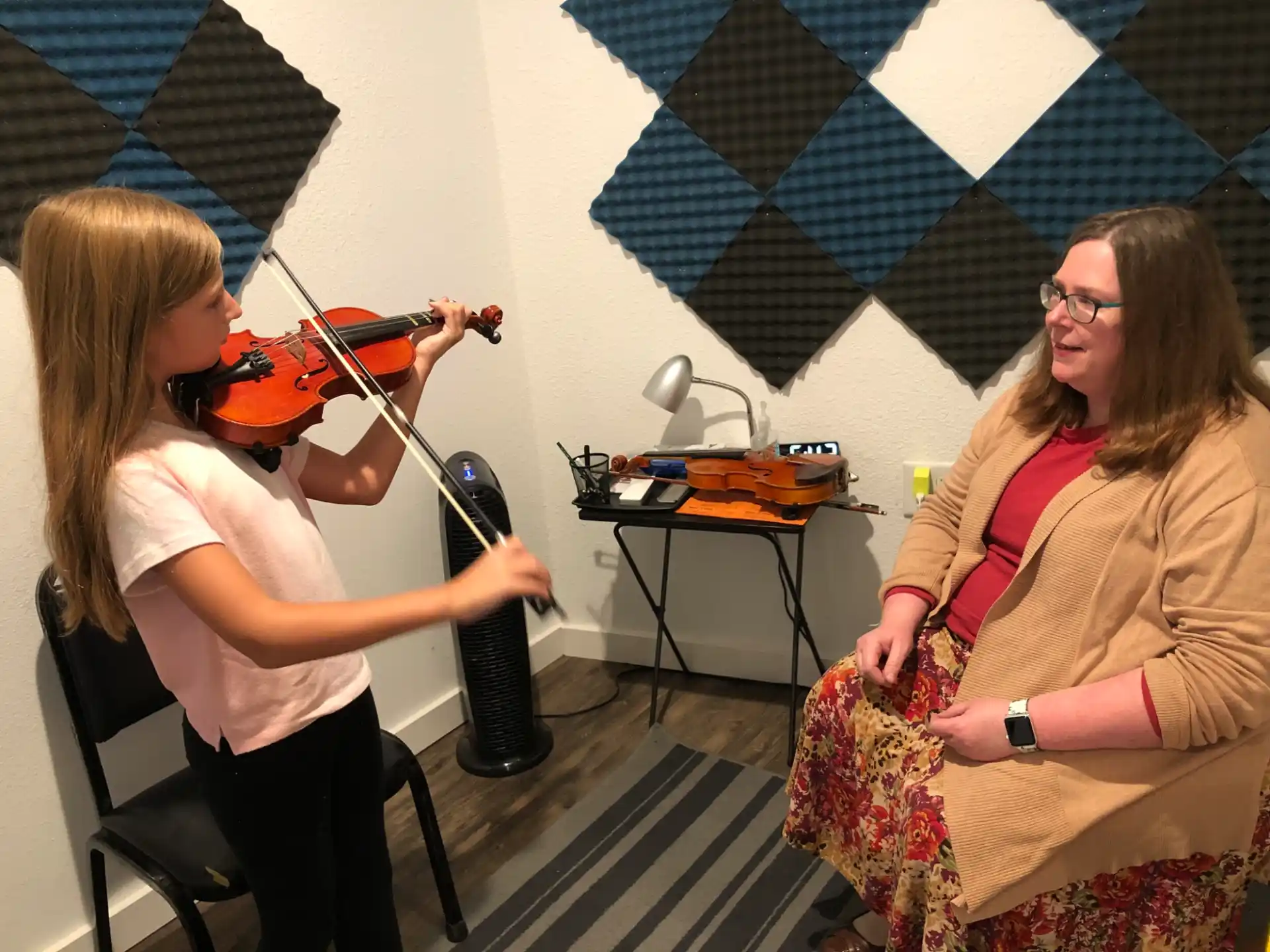 a woman playing a violin