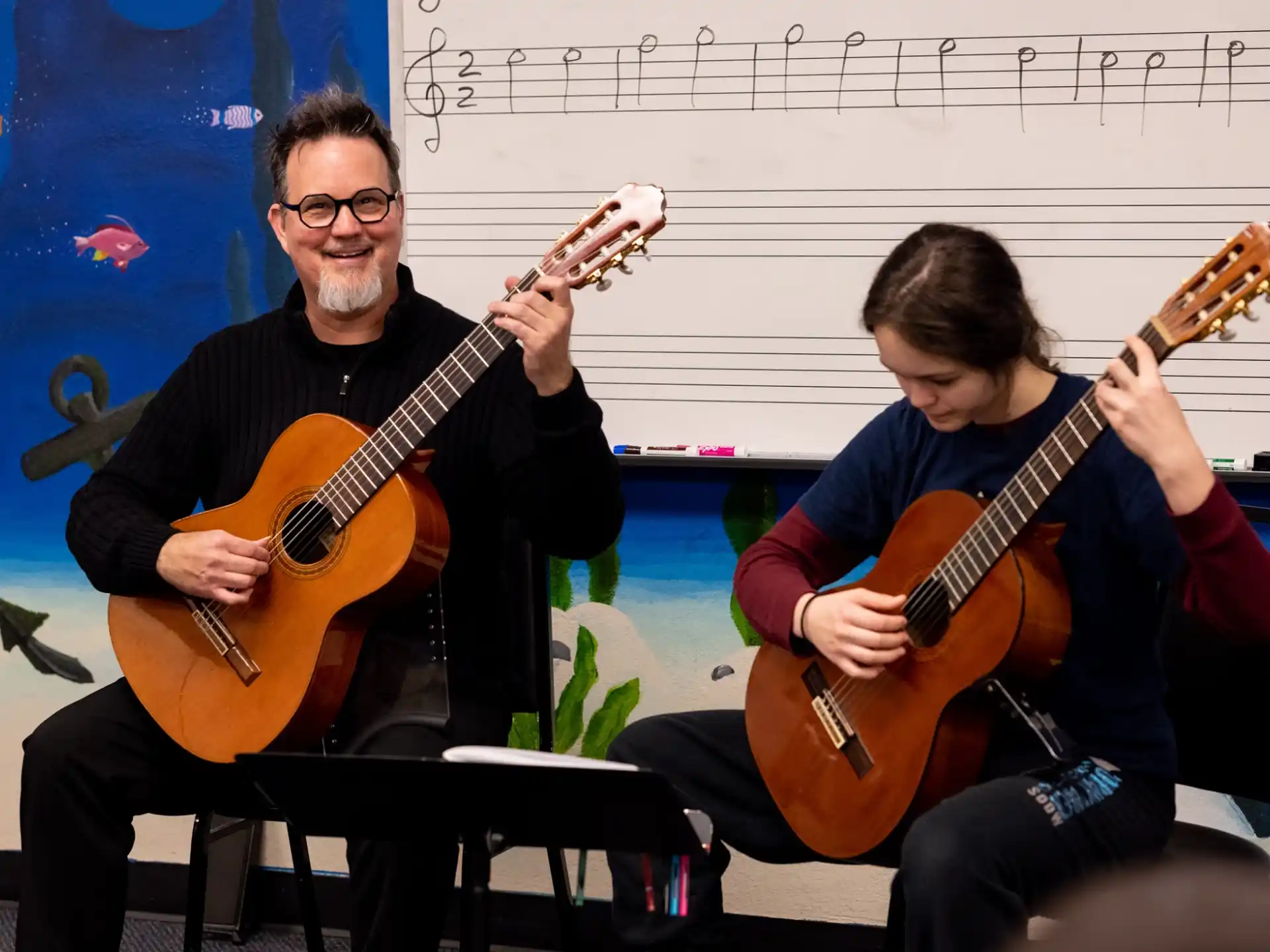 a couple of men playing guitars
