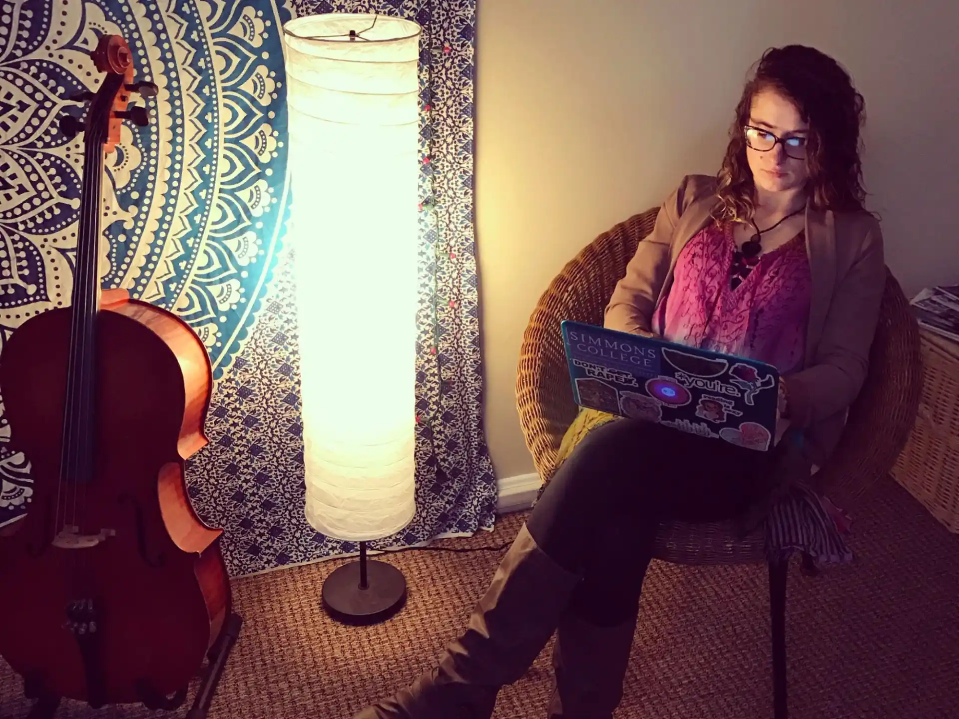 a woman sitting on a chair with a laptop