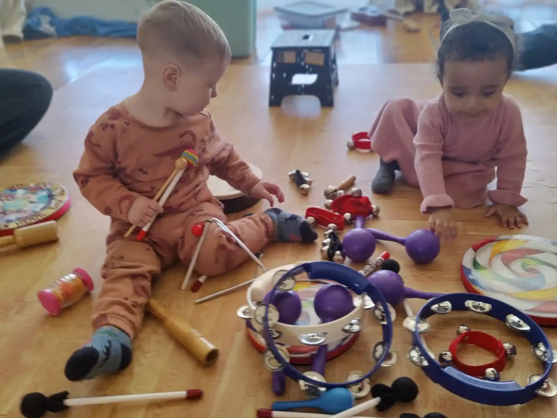 a couple of babies playing with toys