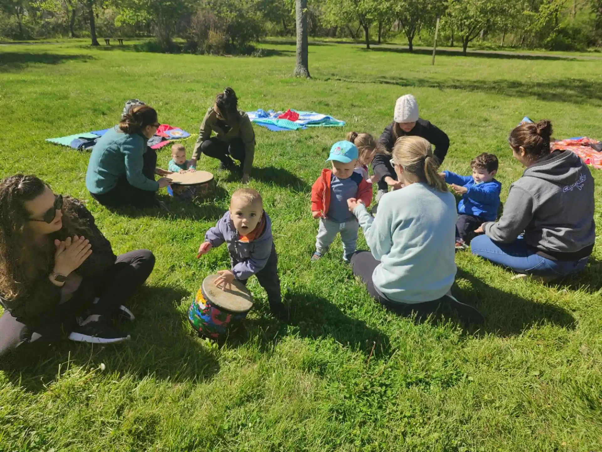 a group of people sitting on the grass
