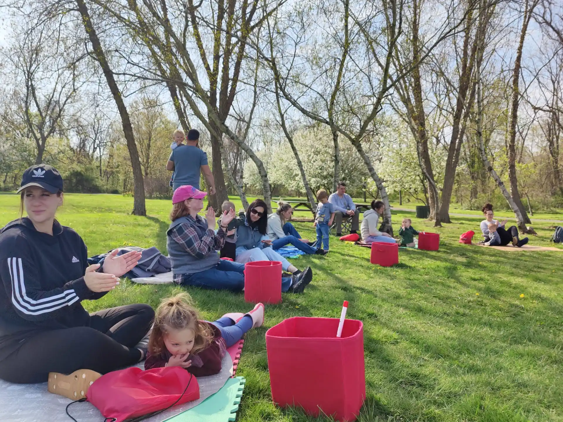 a group of people sitting on the grass
