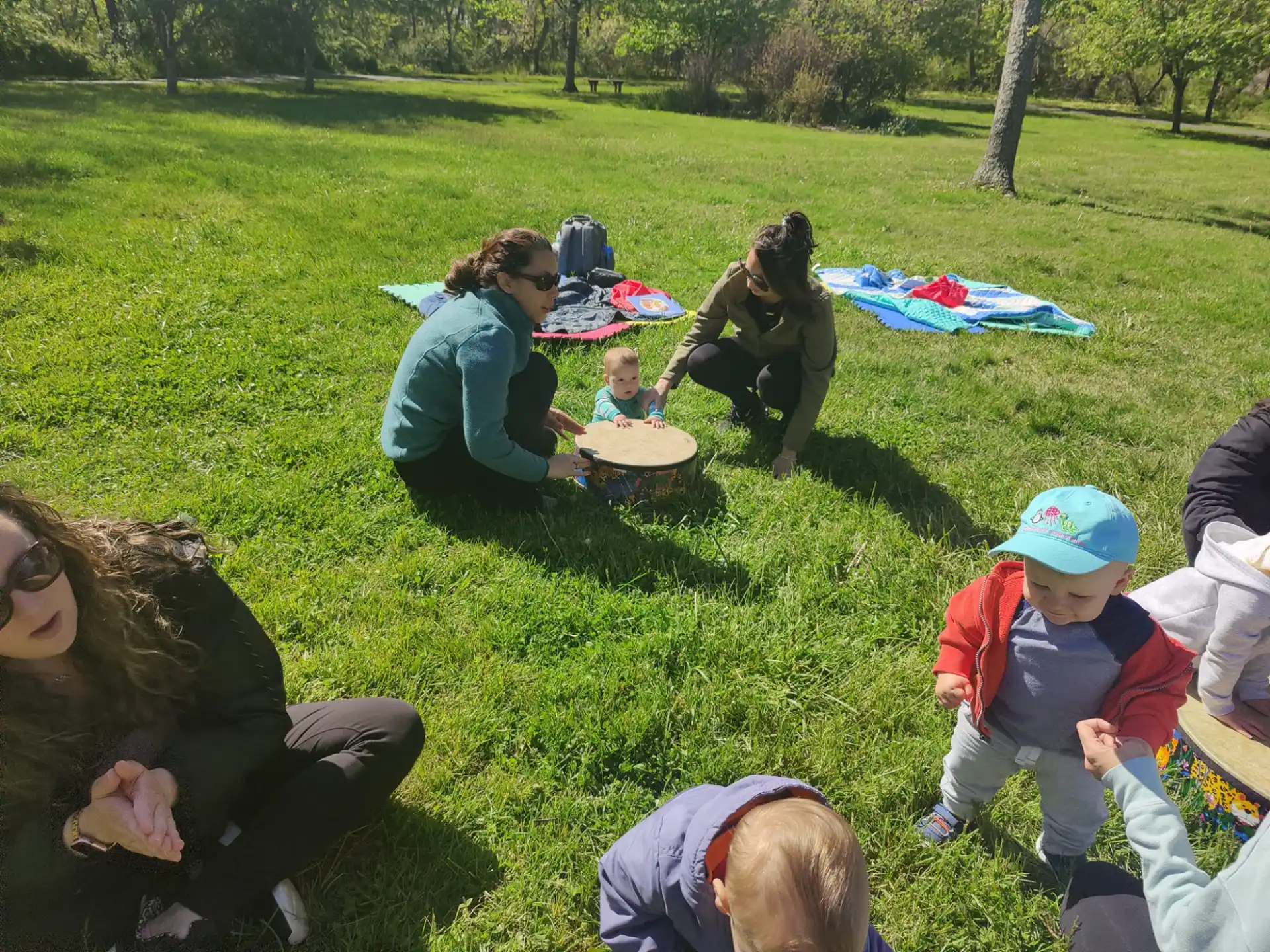 a group of people sitting on the grass