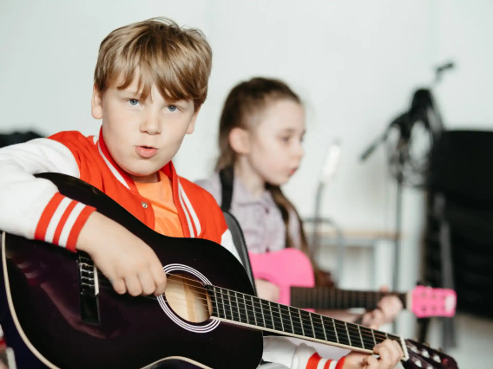 a boy playing a guitar