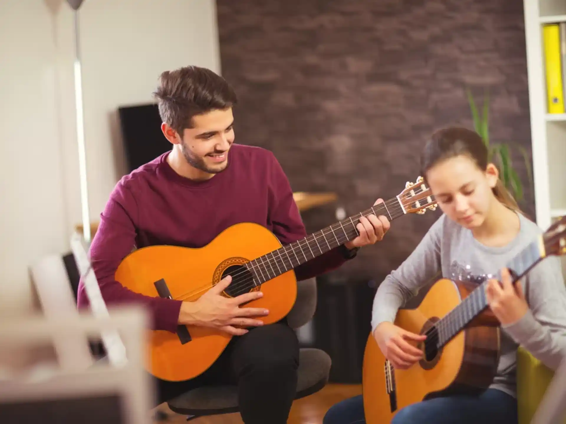 a couple of men playing guitars