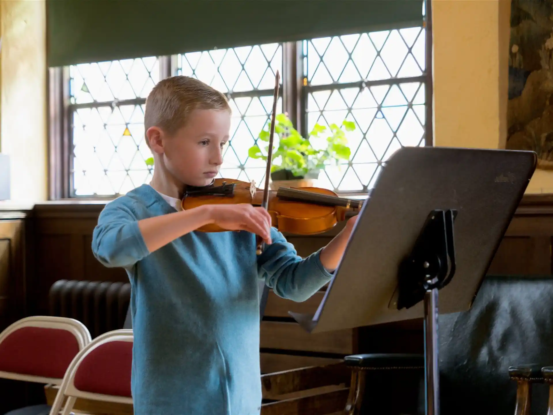 a boy playing a piano