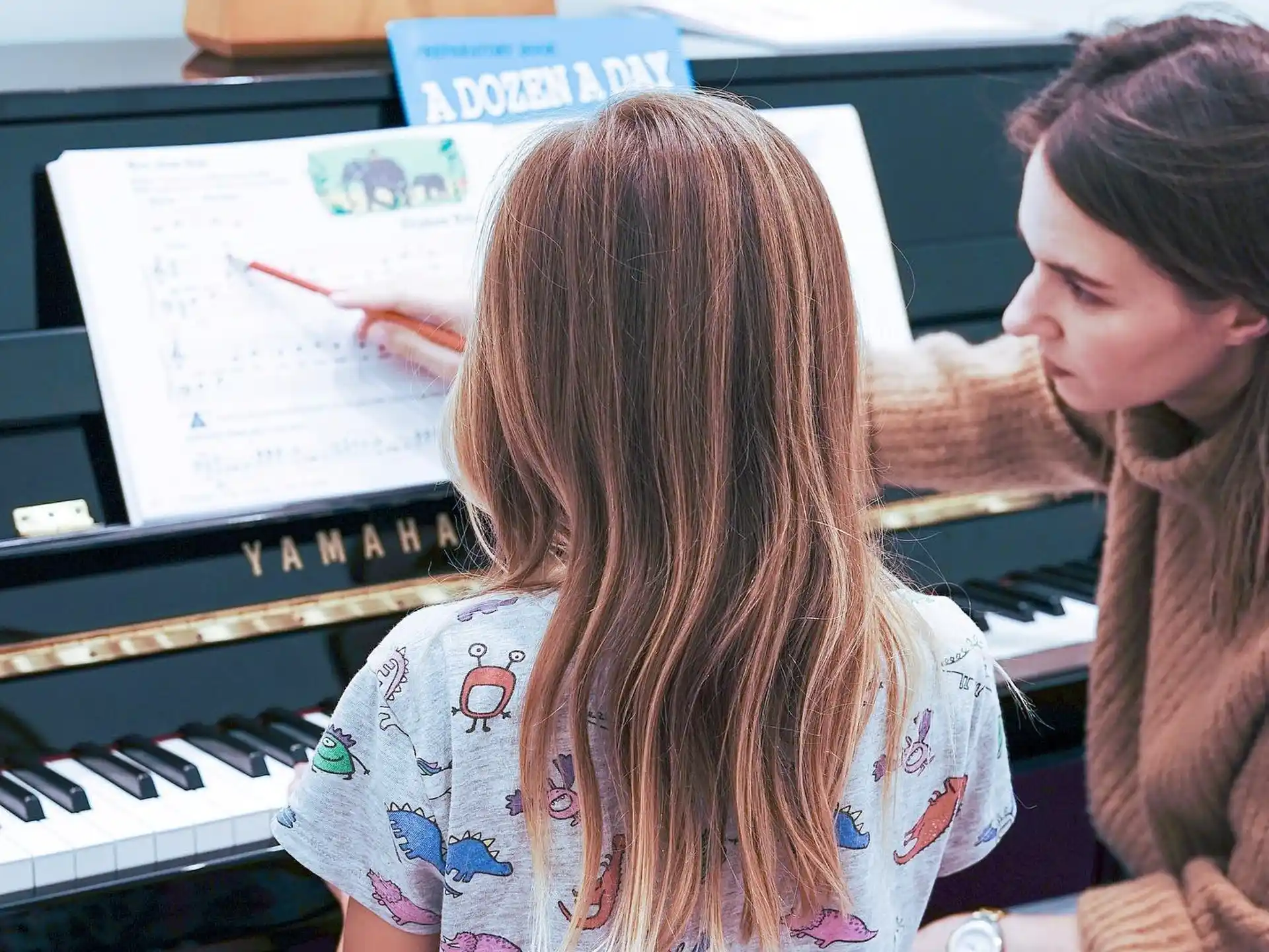 a woman and a girl looking at a computer screen