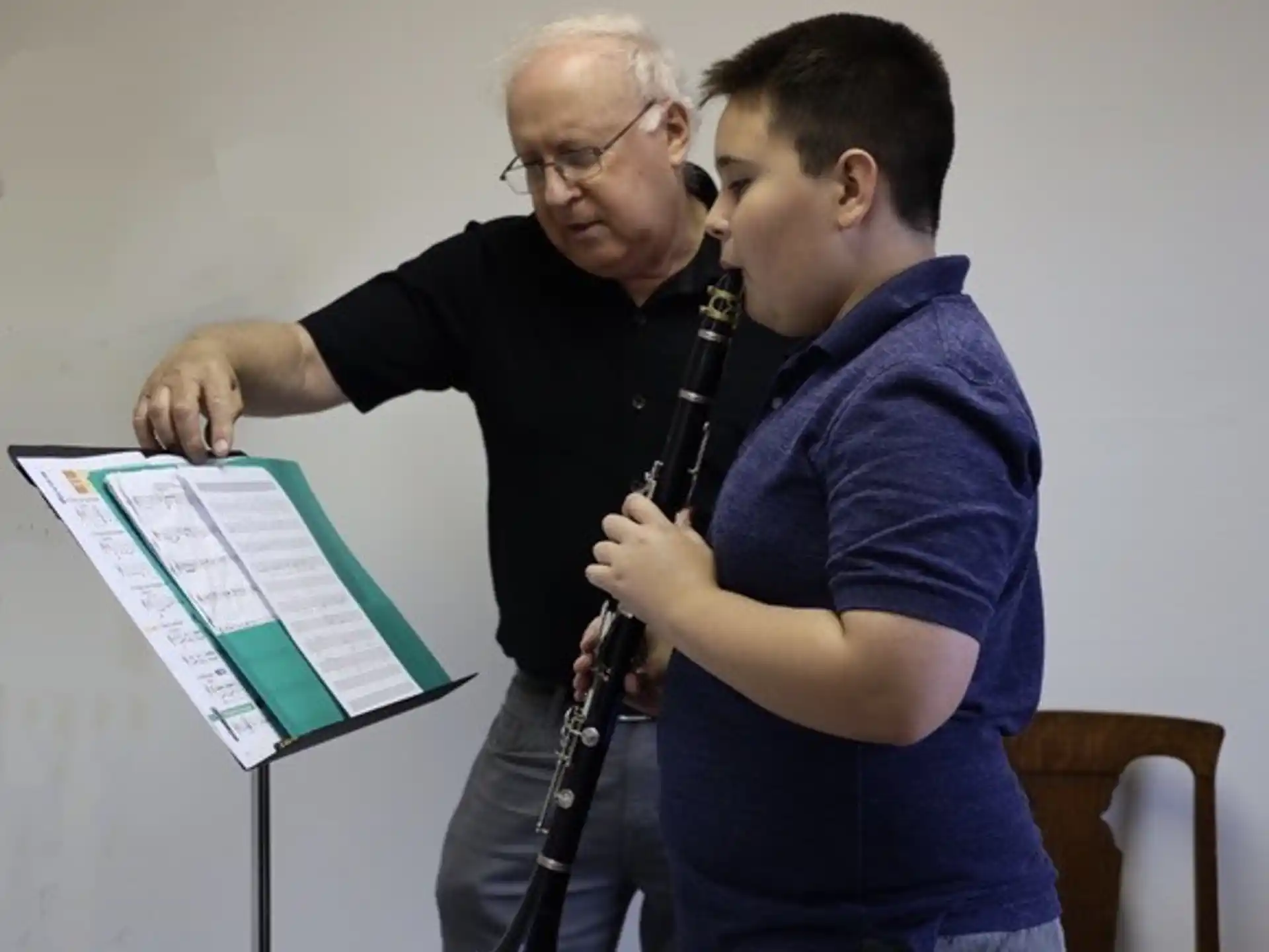 a person showing a person something on the paper