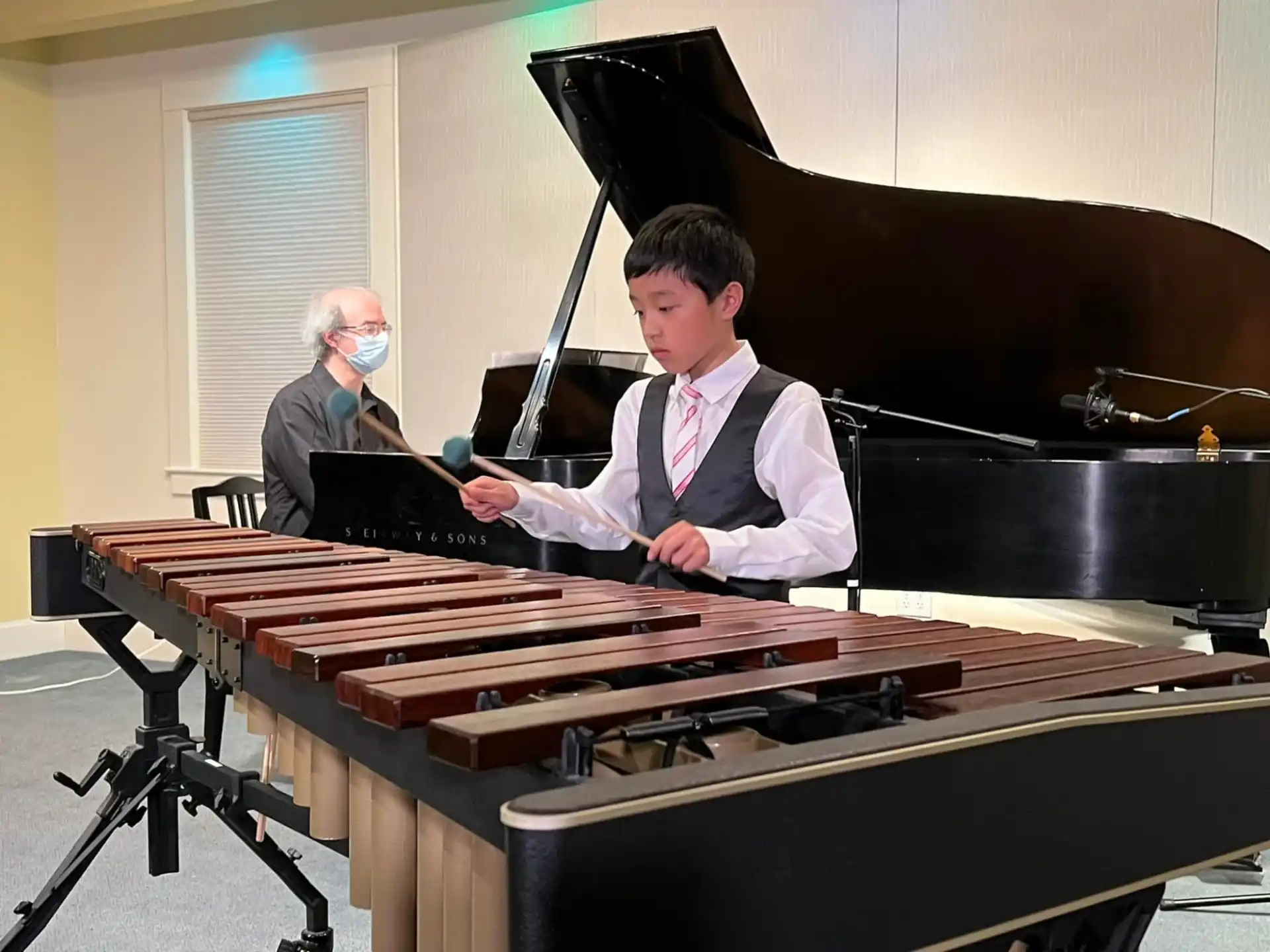 a boy playing a piano