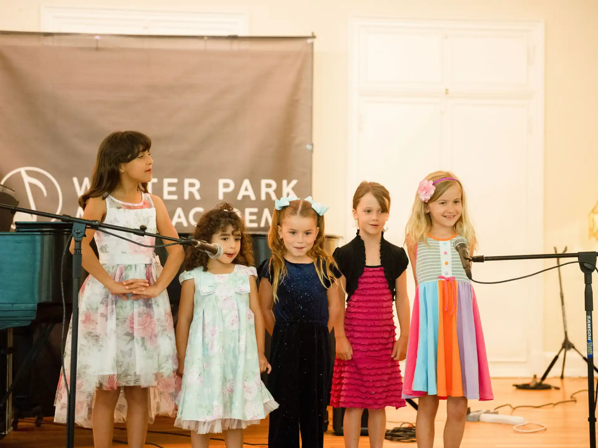 a group of girls in dresses