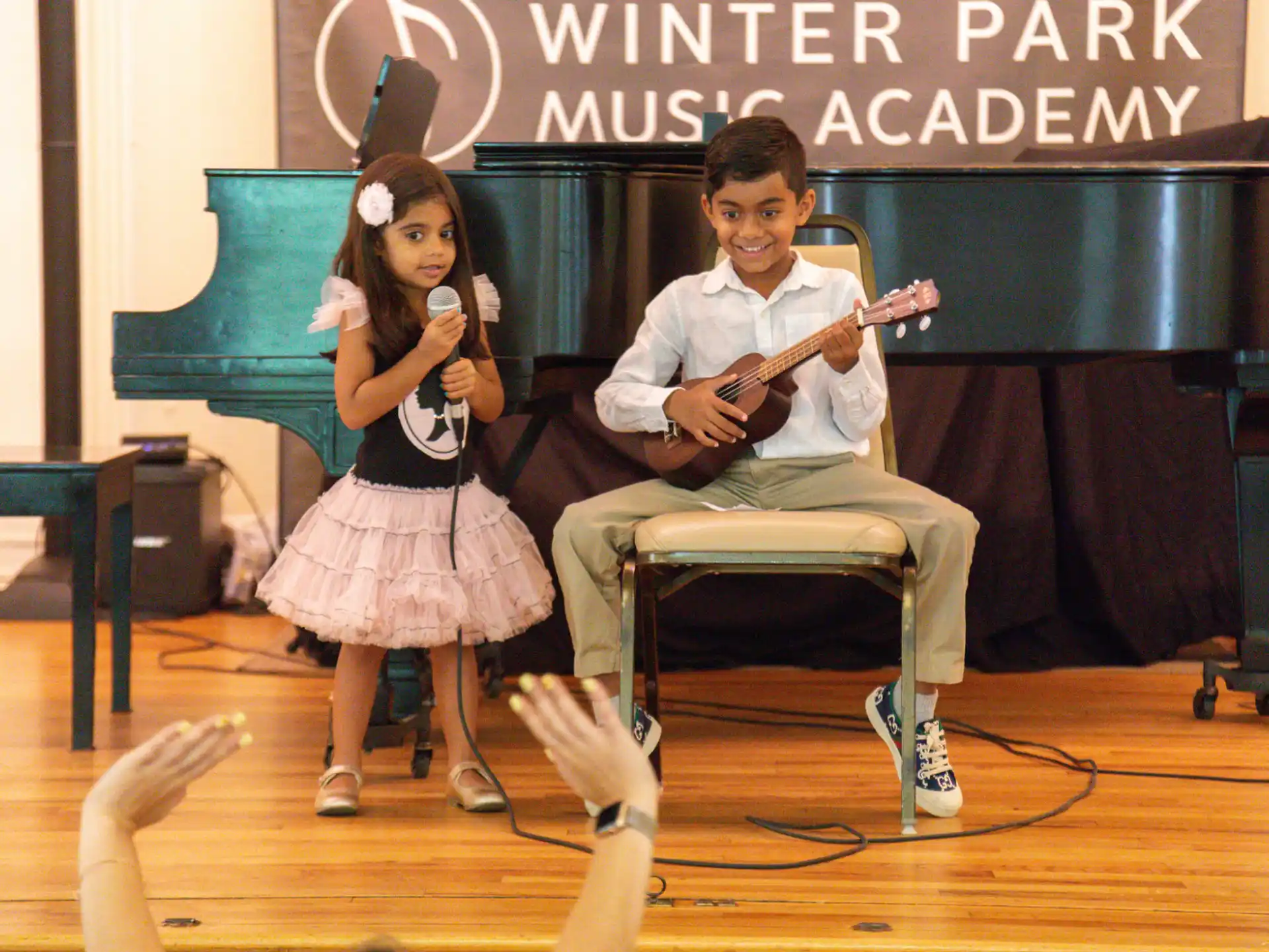 a man and woman singing on a stage