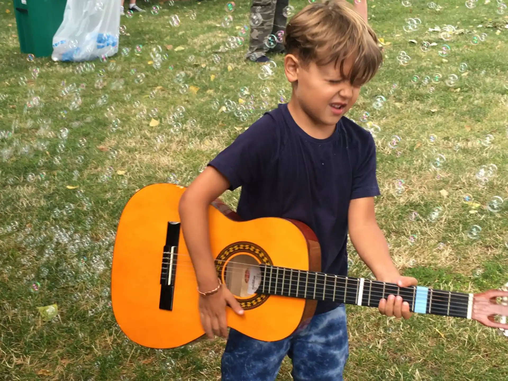 a boy playing a guitar