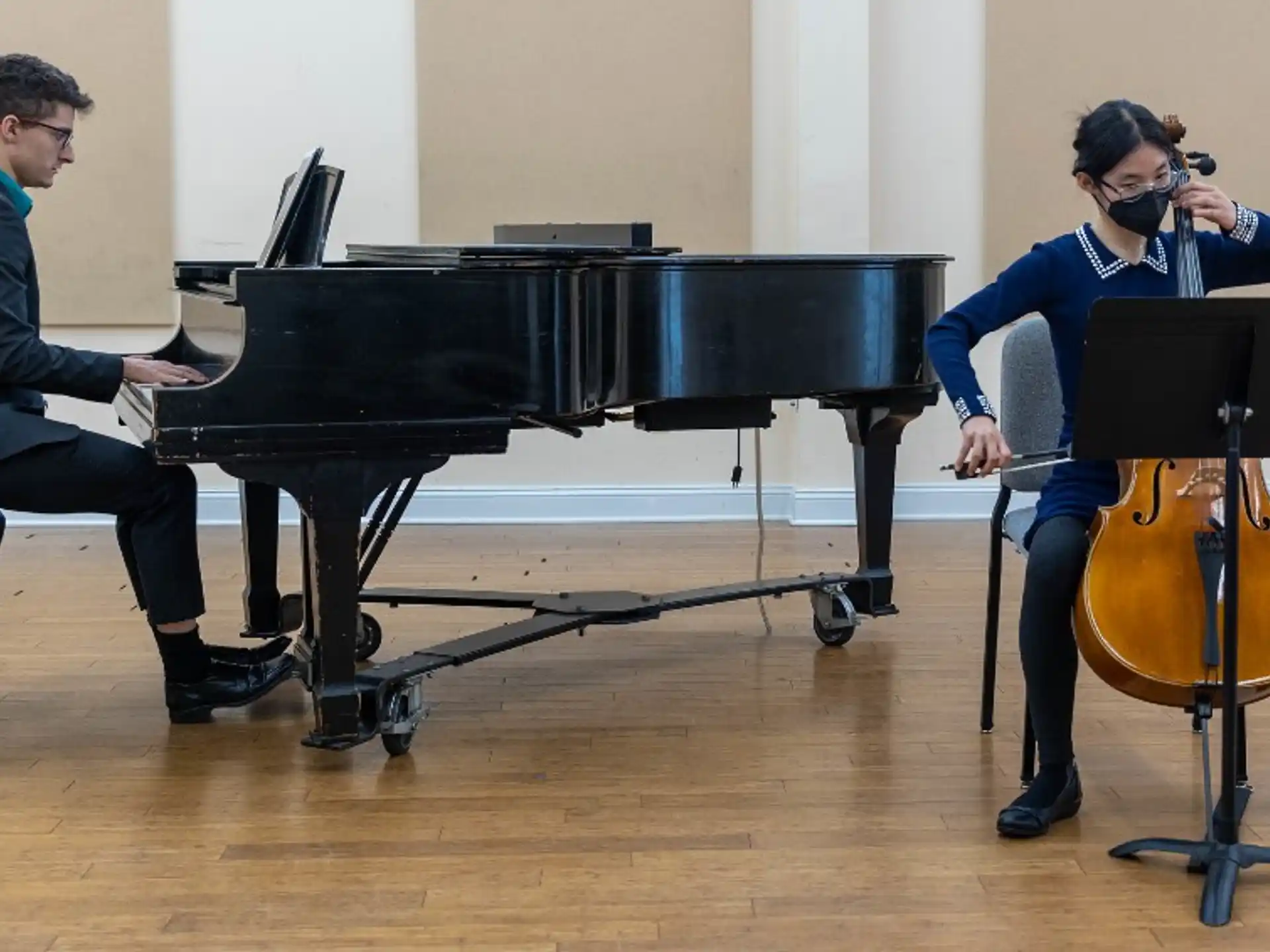 a man and a woman playing the piano
