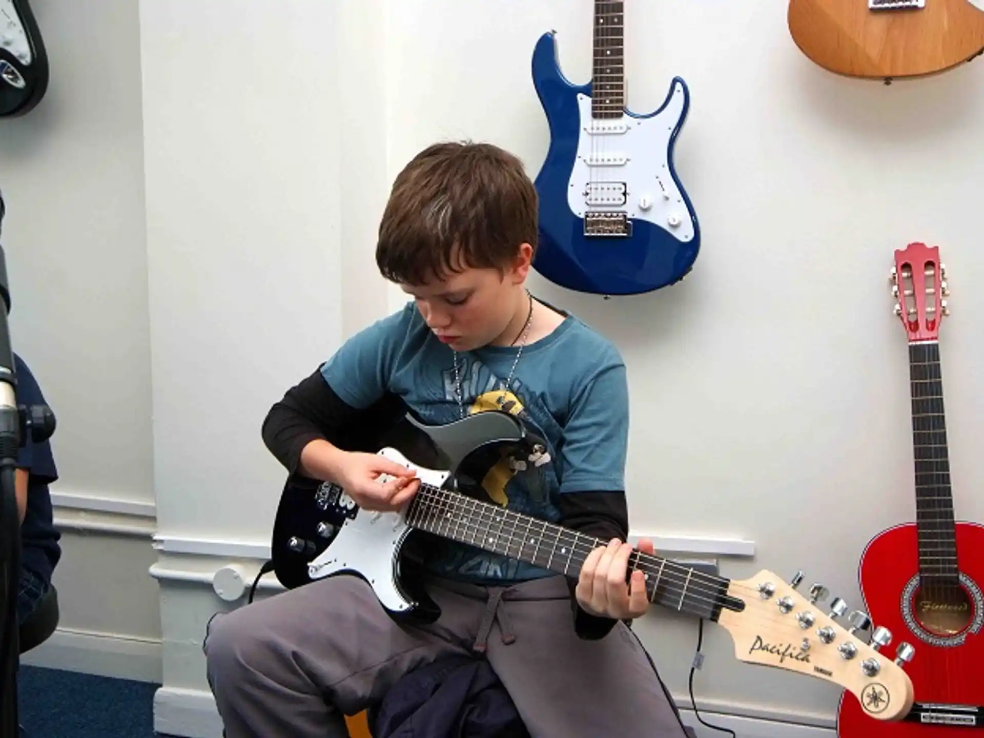 a boy playing a guitar
