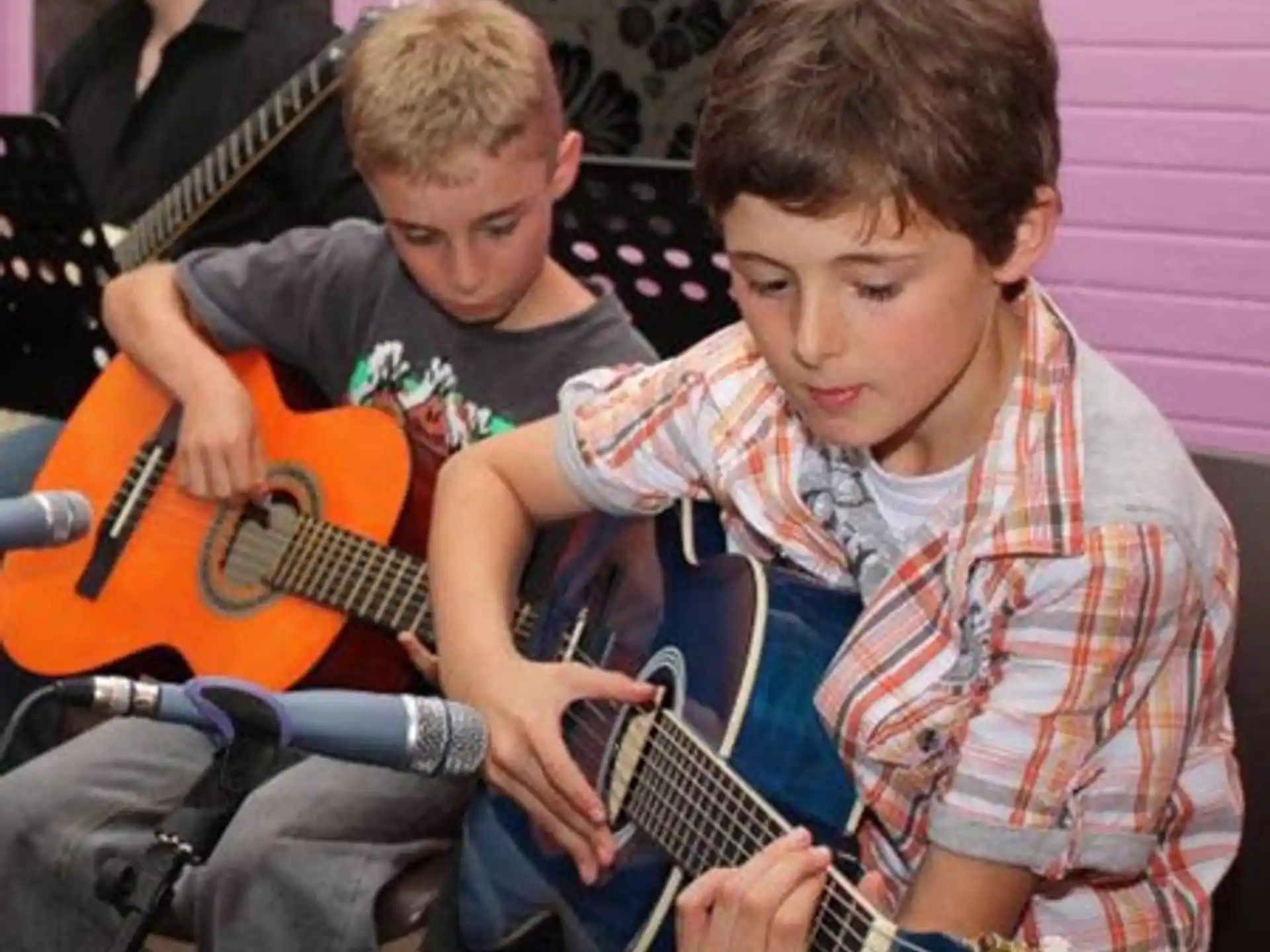 a group of people playing guitars
