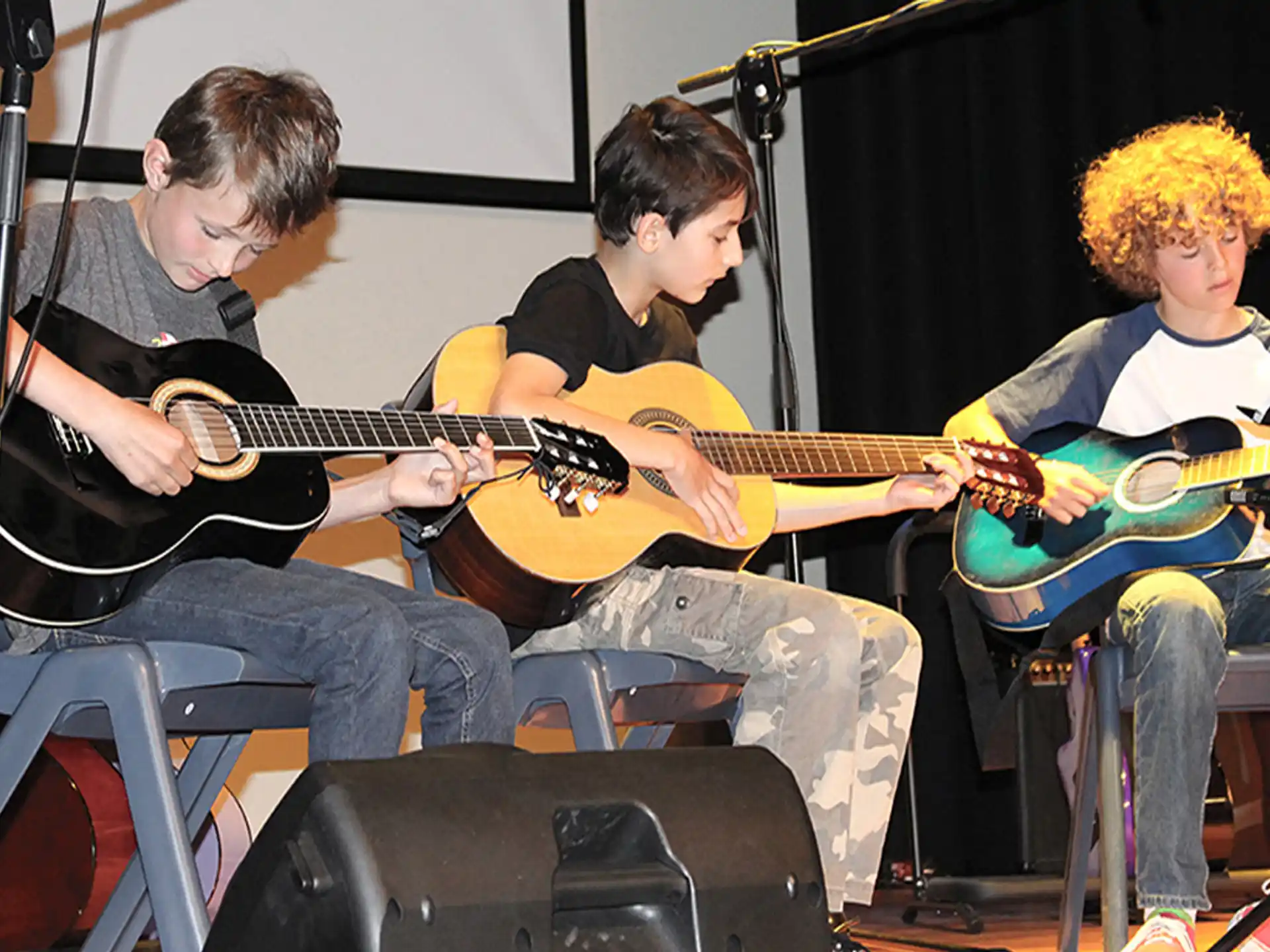 a group of people playing guitars