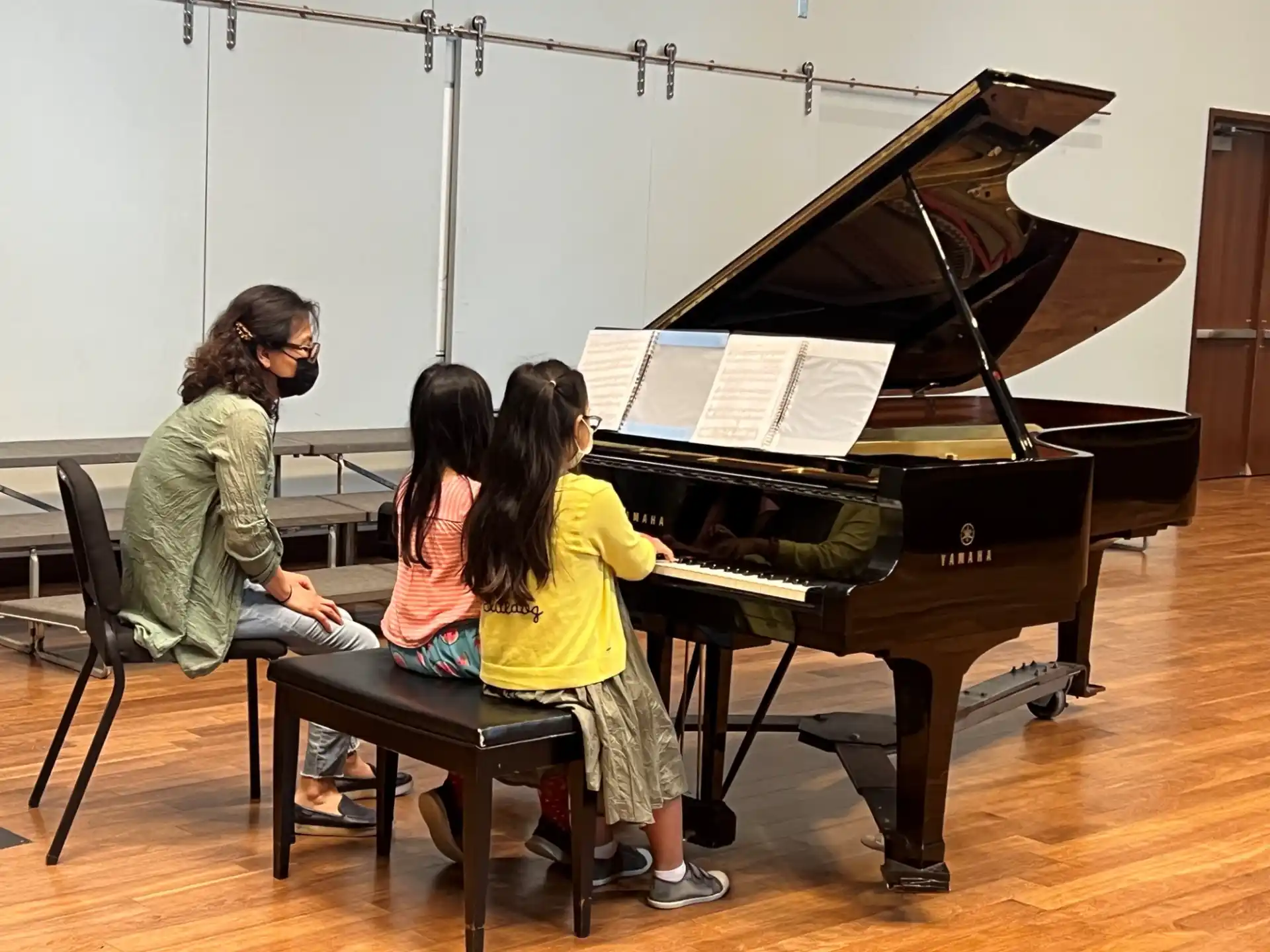 a group of people playing piano