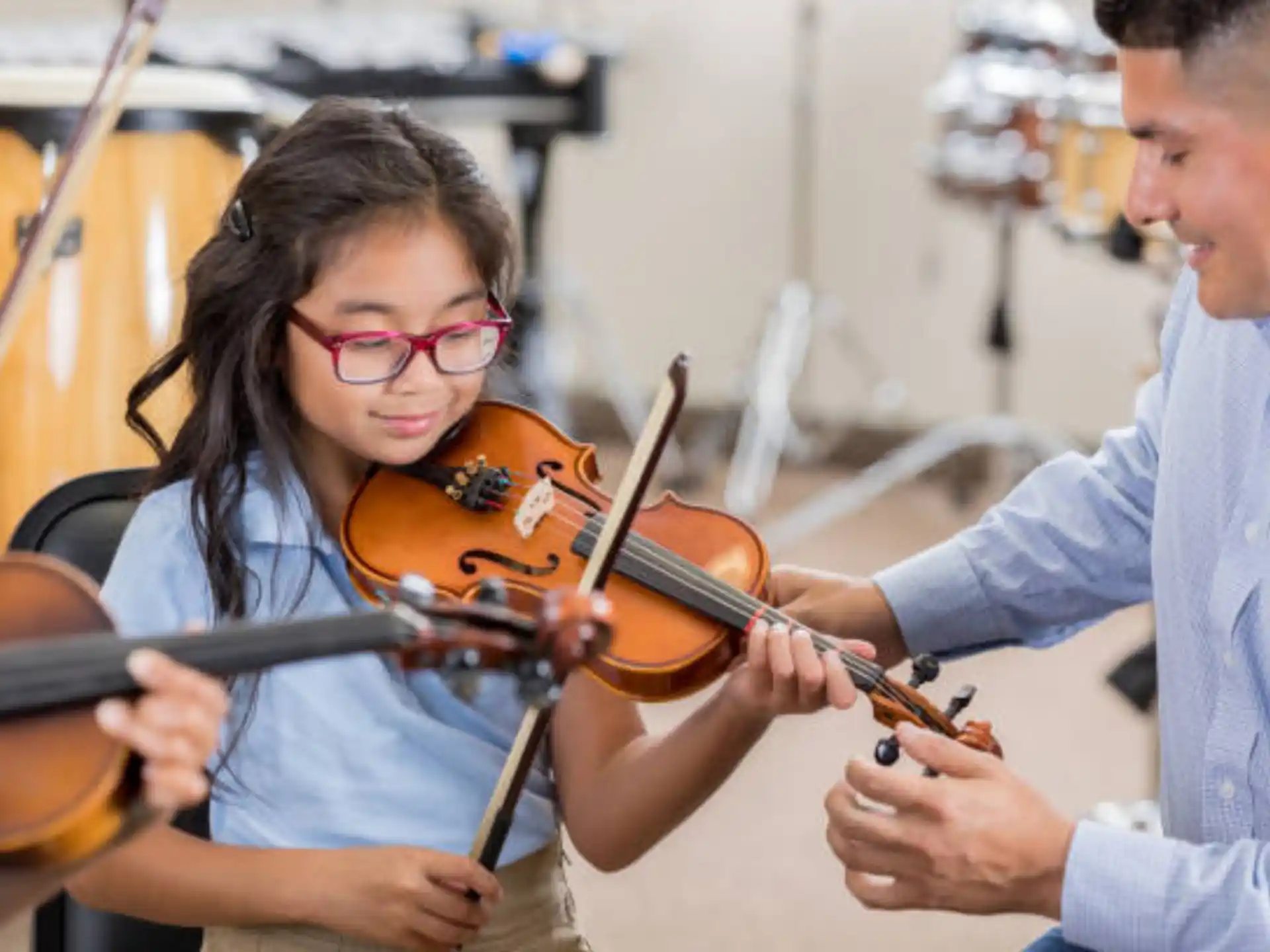 a man and a woman playing the violin