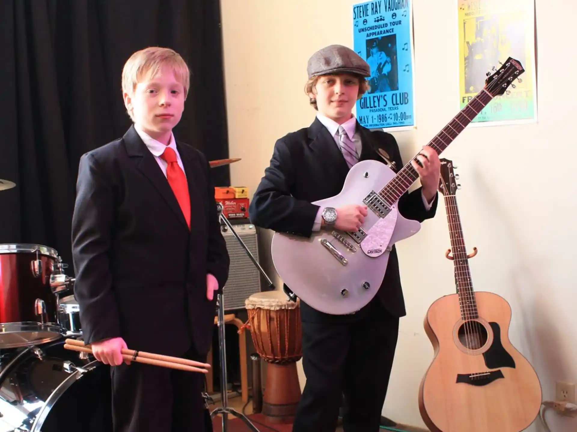 a couple of men holding guitars