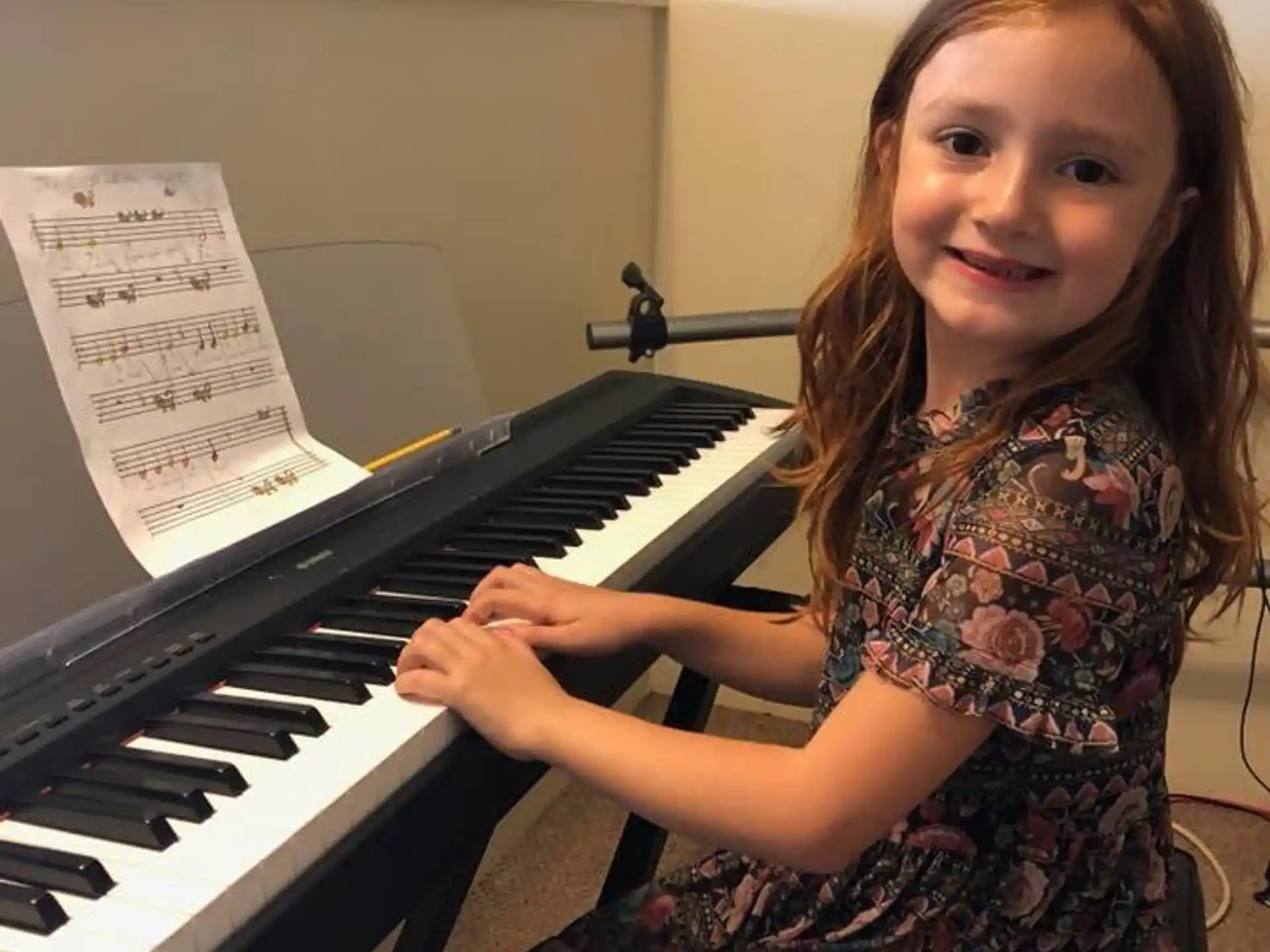 a girl playing a piano