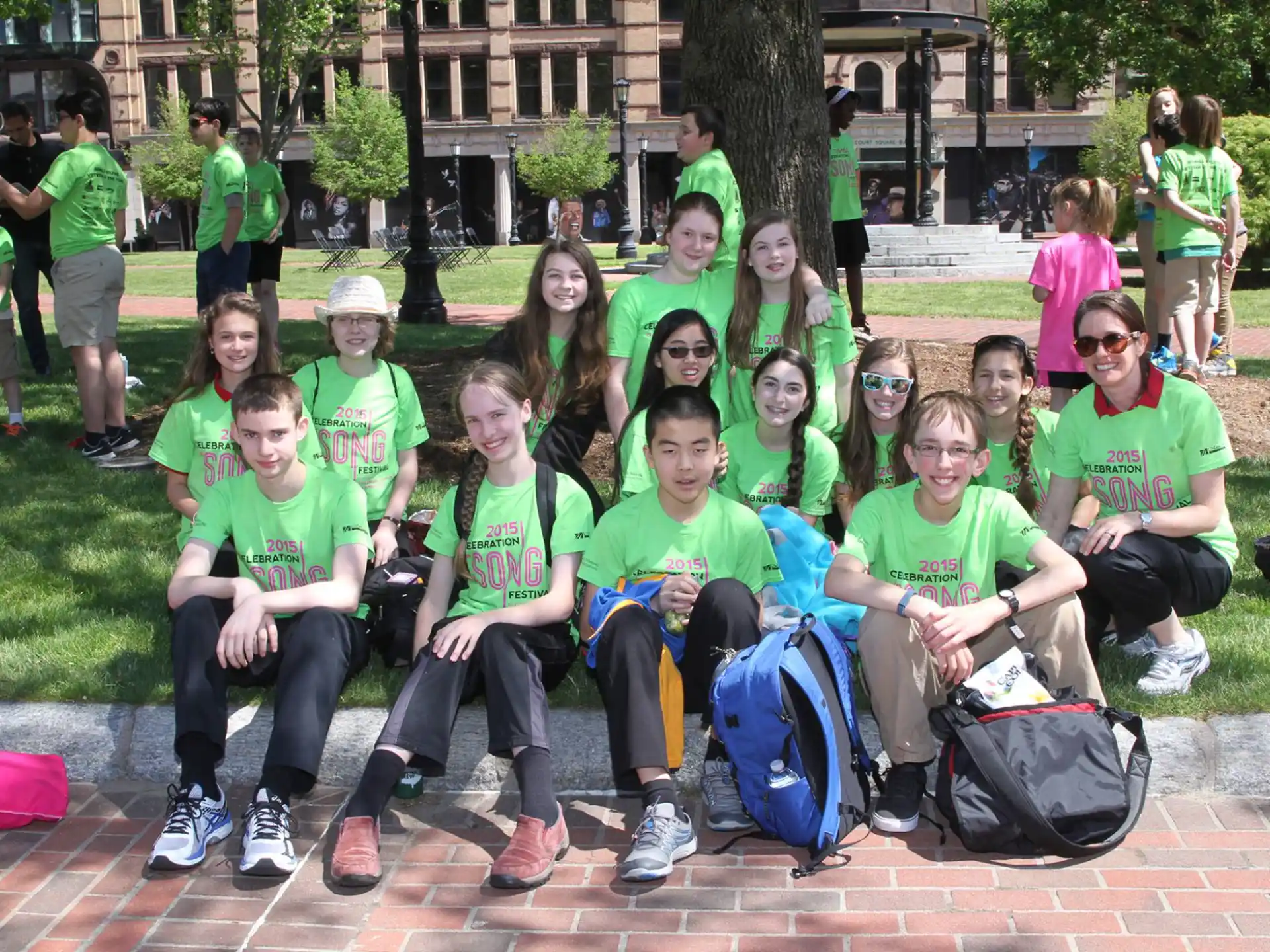 a group of people wearing green shirts