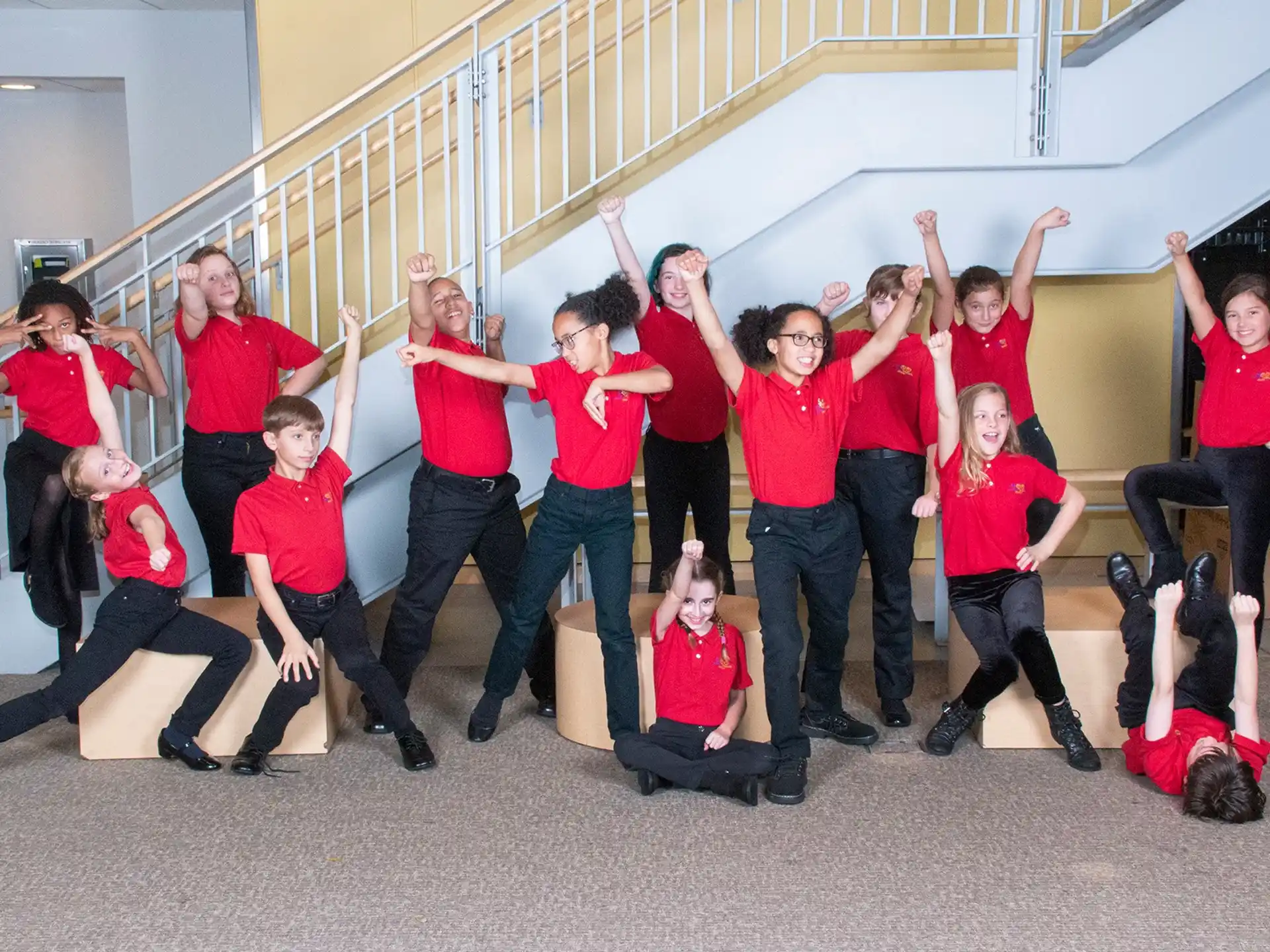 a group of people wearing red shirts and posing for a photo
