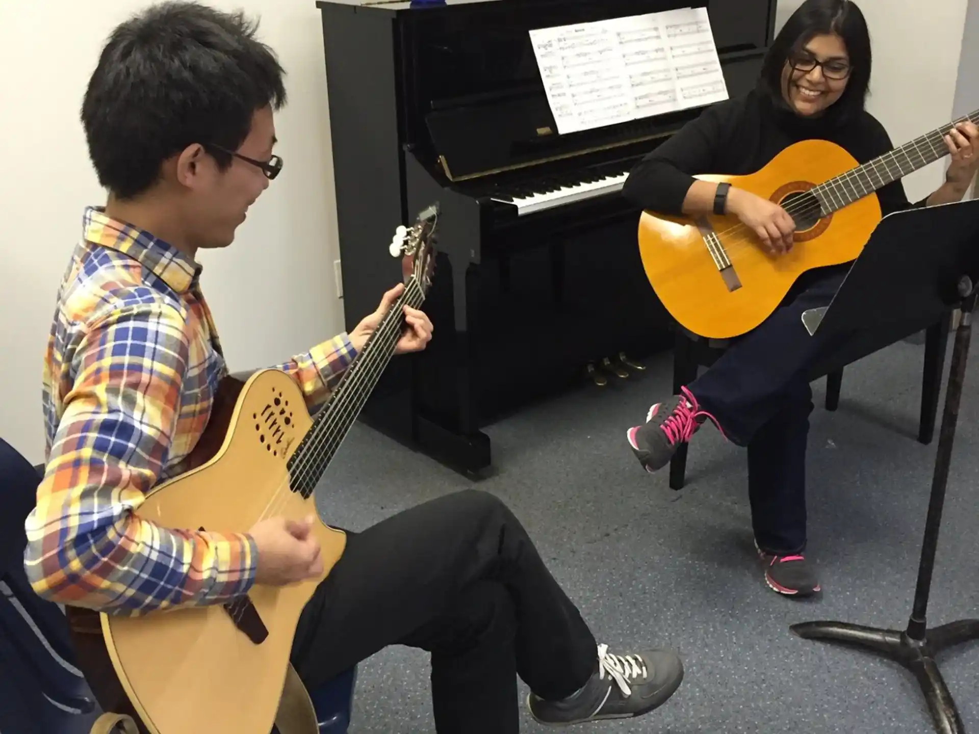a man and woman playing guitars