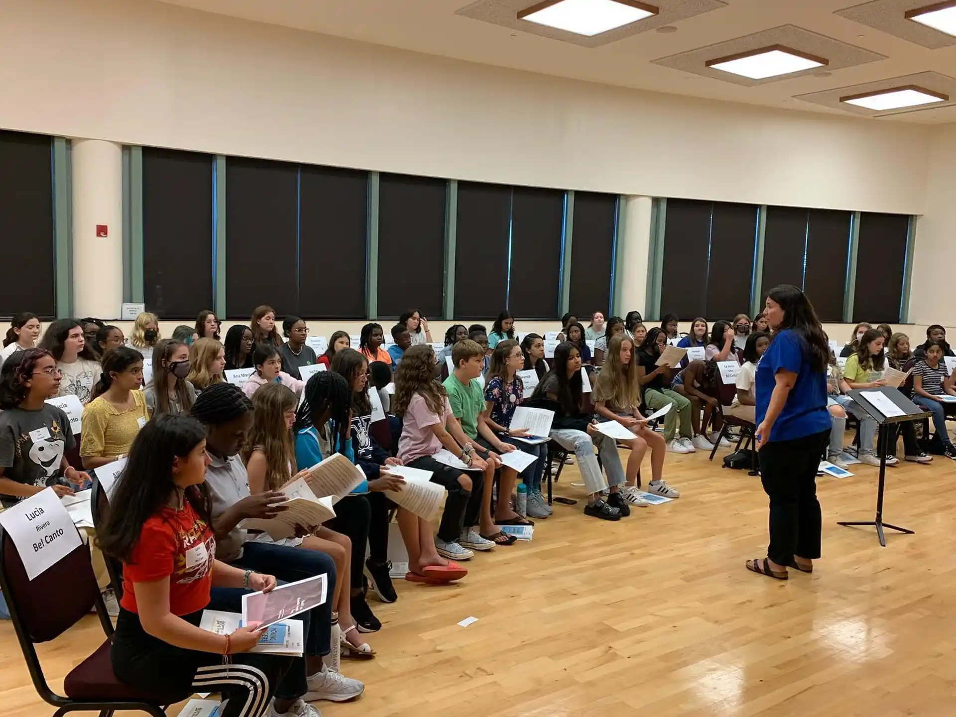 a person standing in front of a group of people sitting in chairs