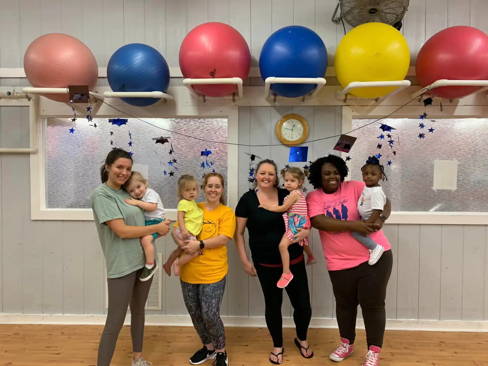 a group of people posing for a photo with balloons