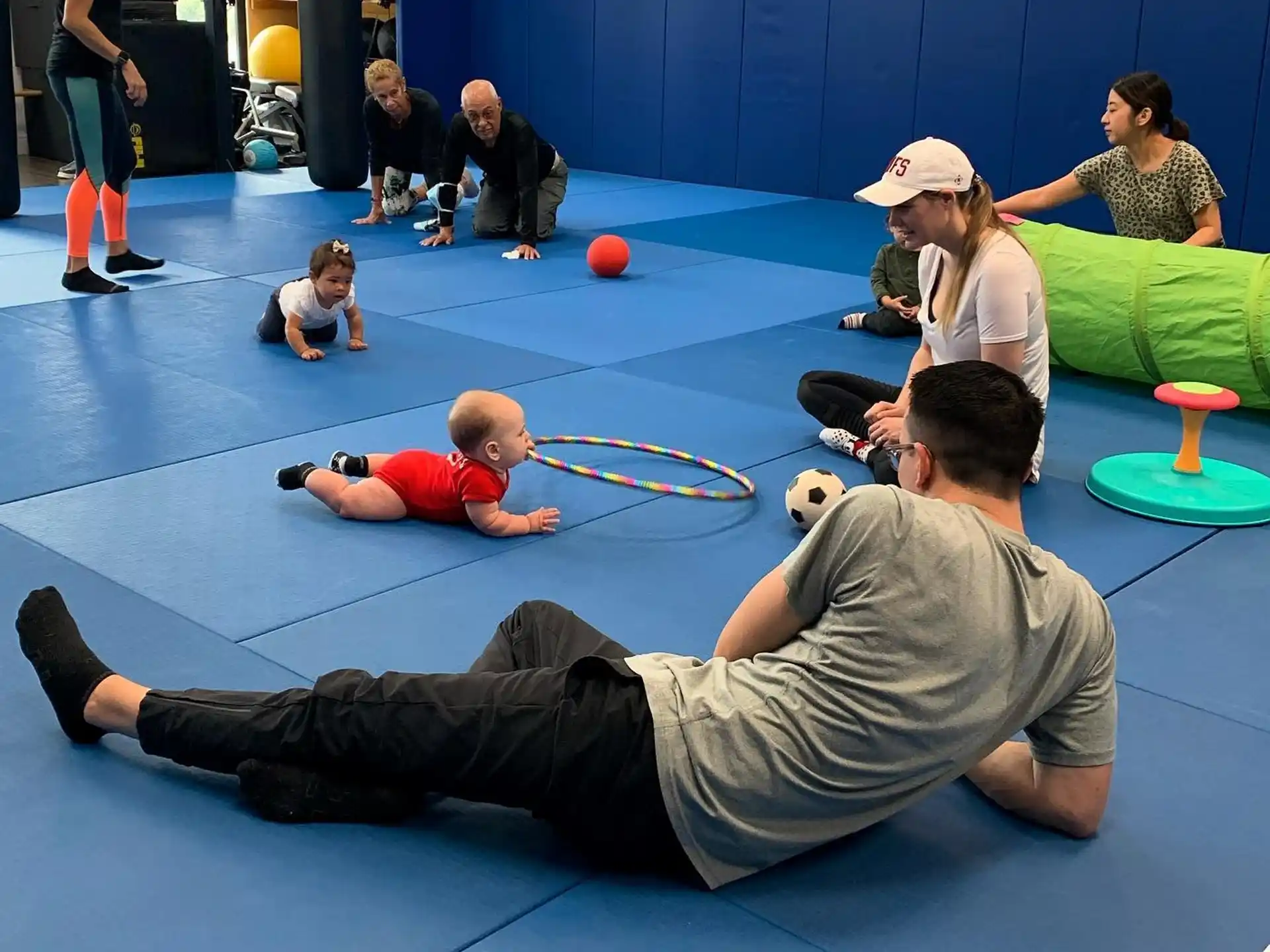 a person lying on the floor with a baby