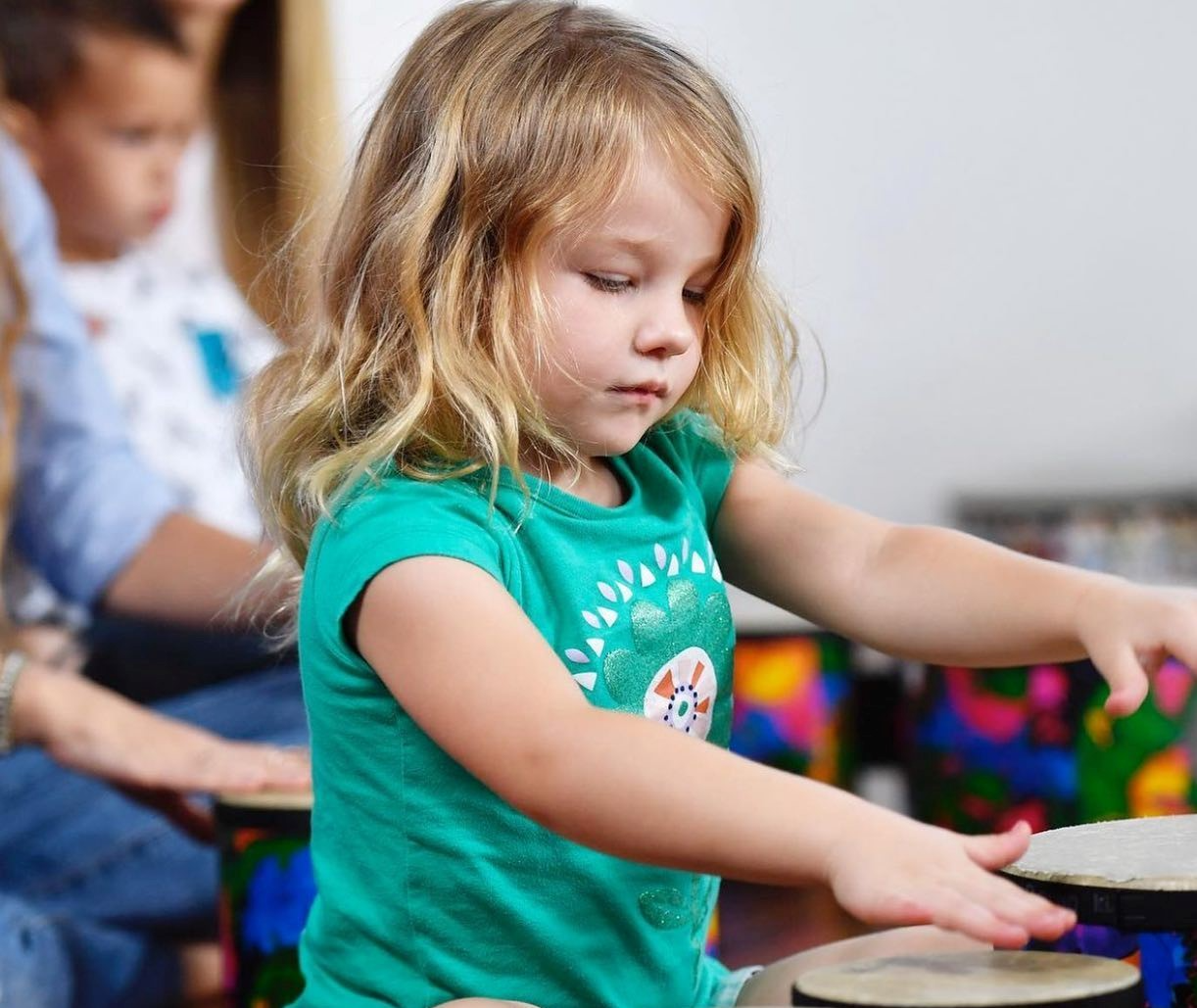 a young girl in a green shirt