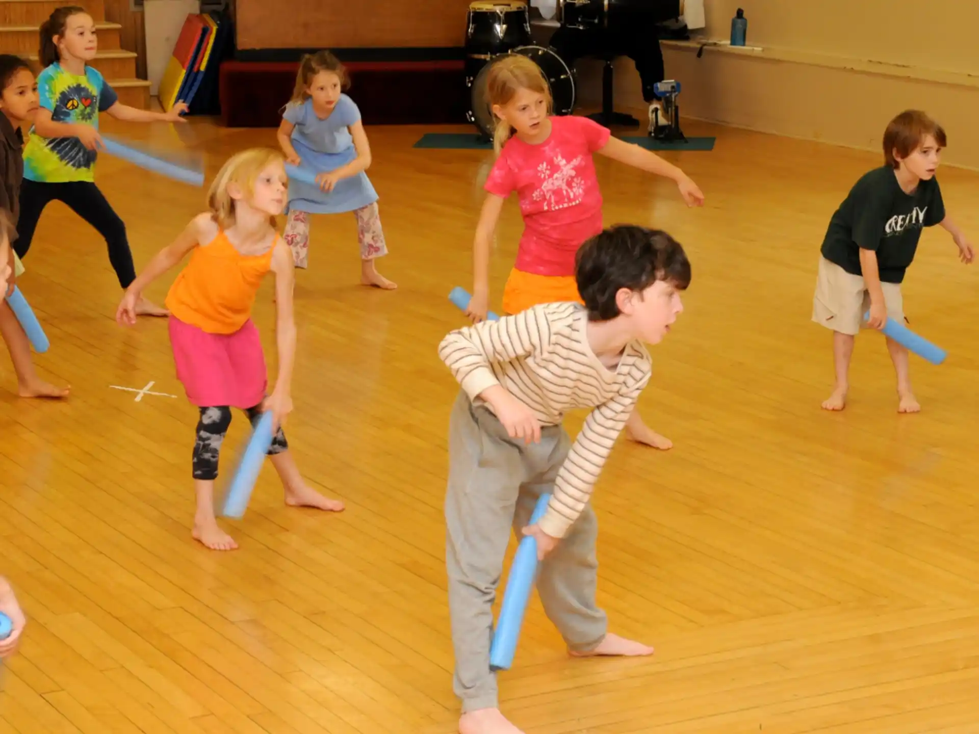 a group of children playing with sticks