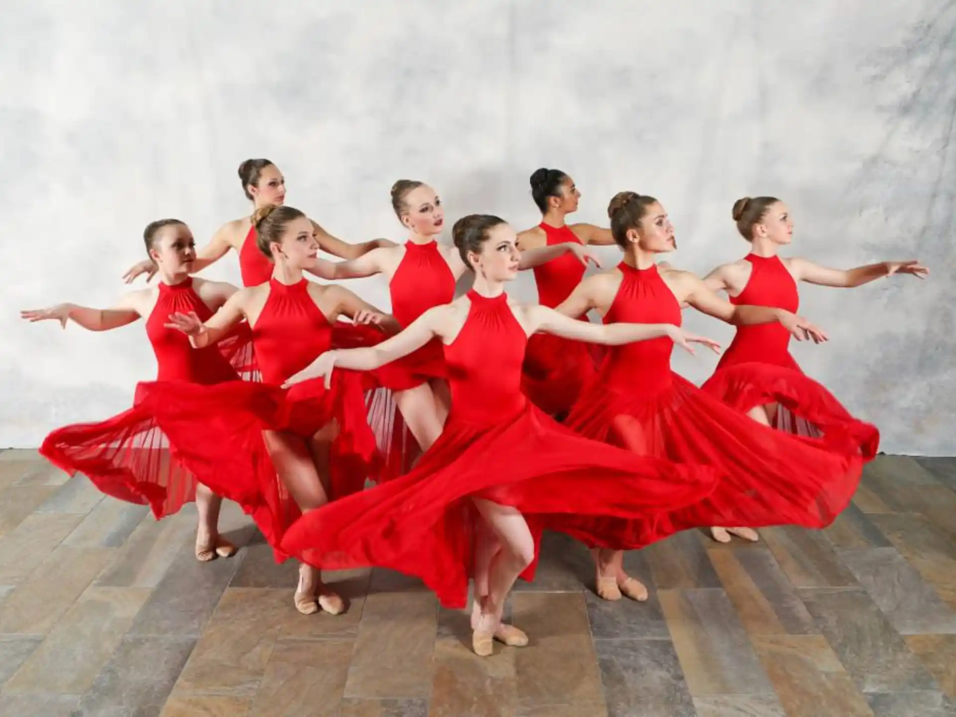 a group of women in red dresses