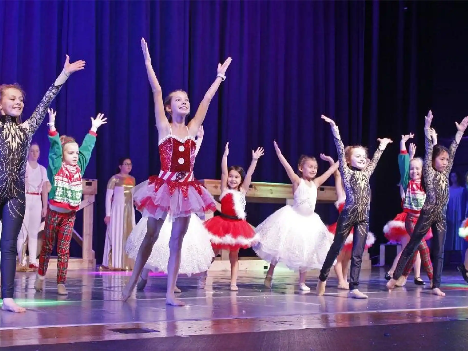 a group of people dancing on a stage
