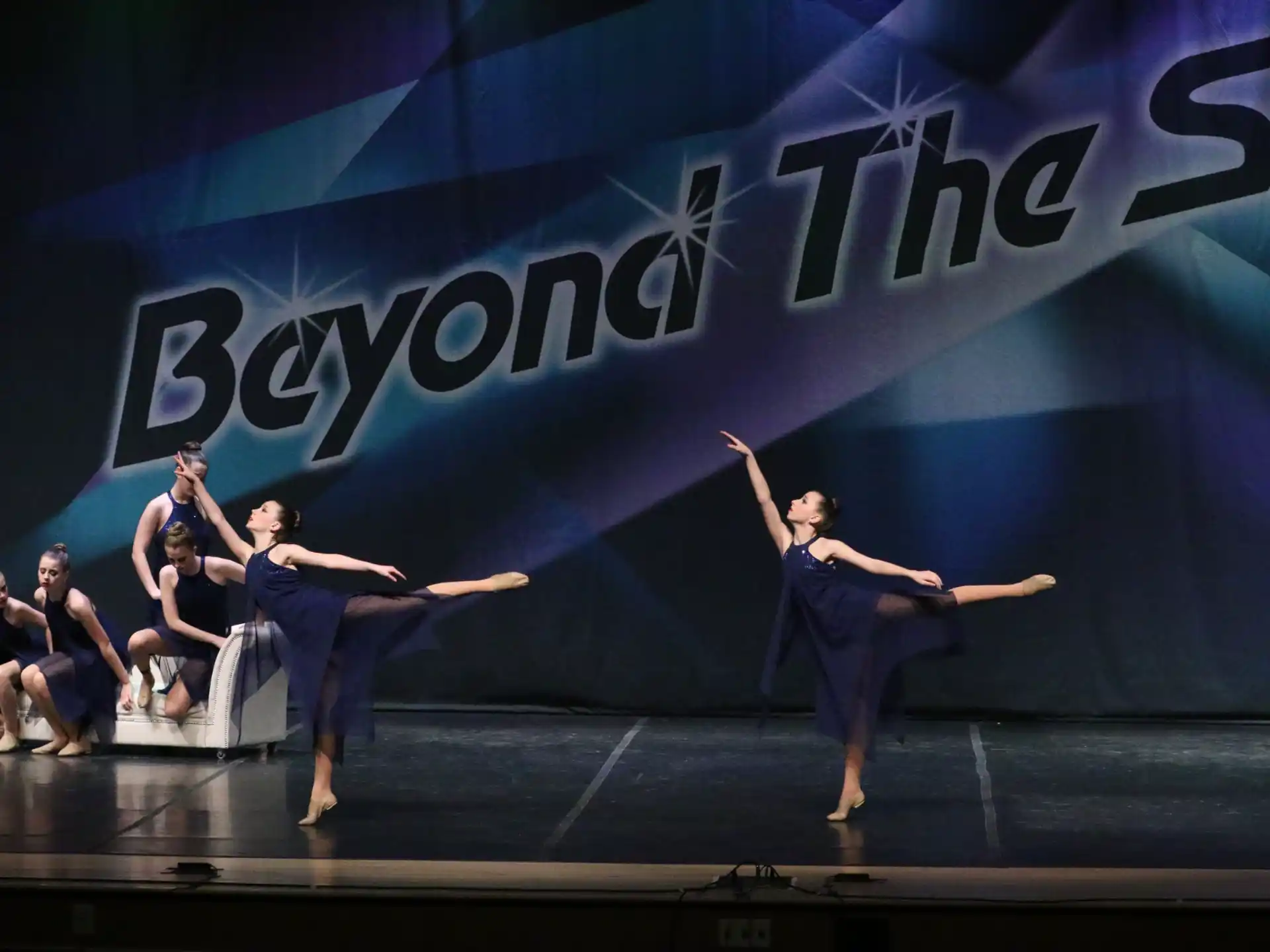 a group of people dancing on a stage