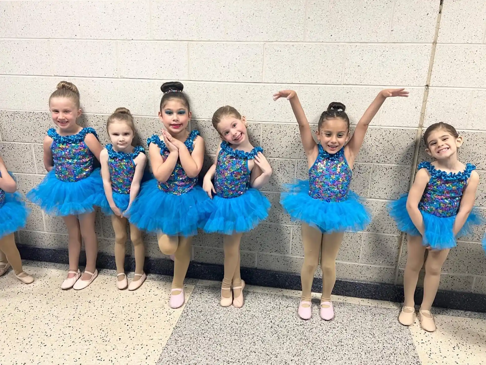 a group of girls in blue dresses