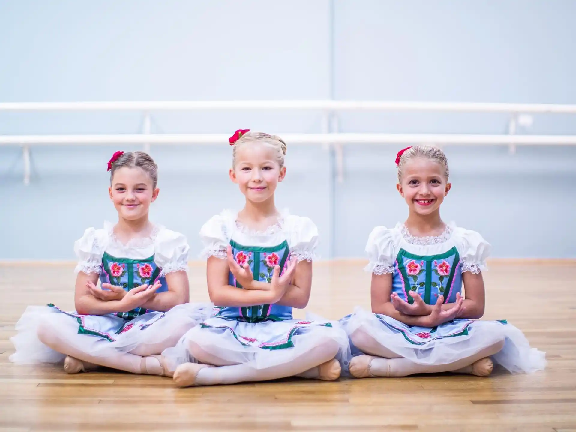a group of girls sitting on the ground