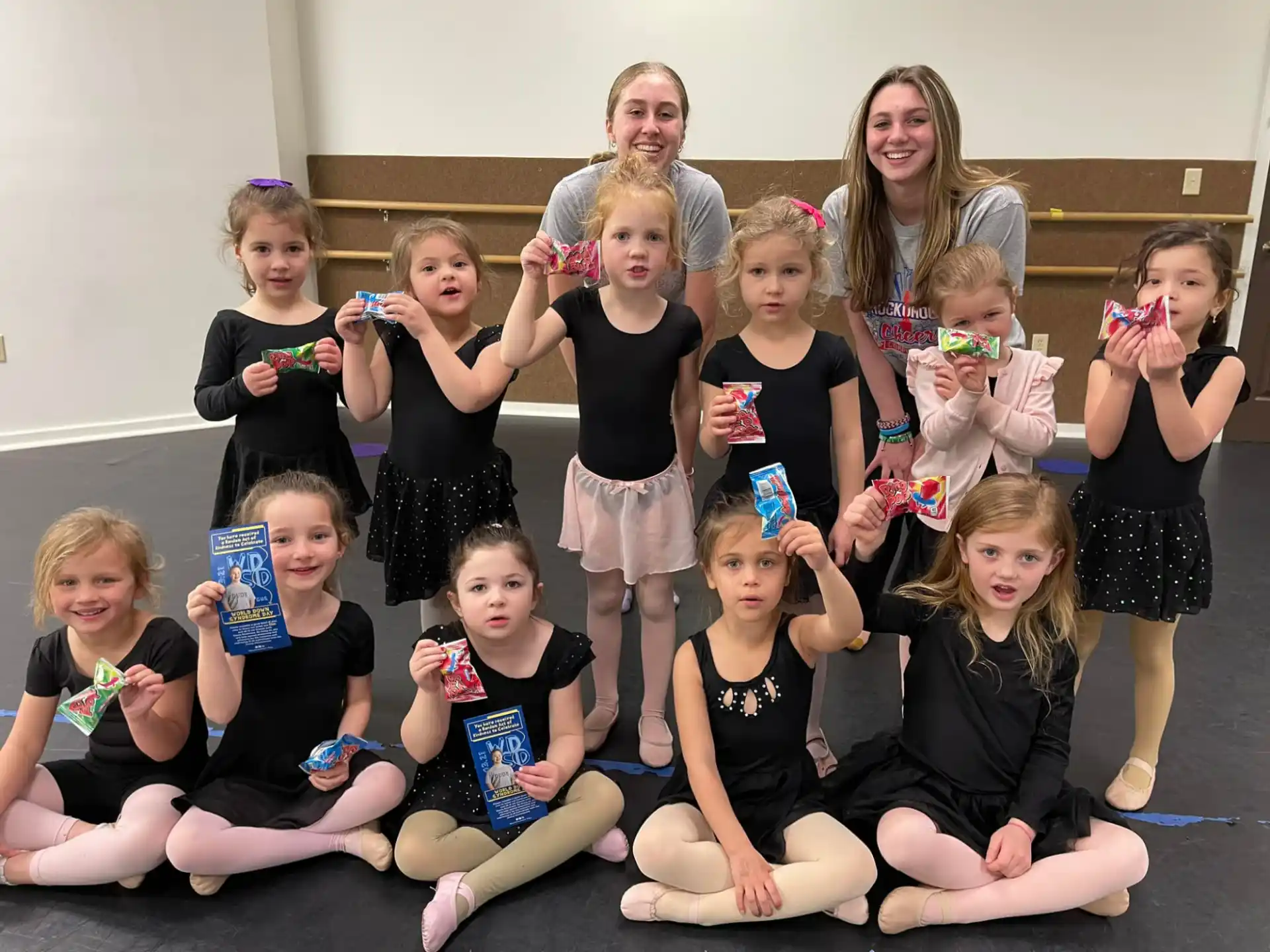 a group of girls holding up cans