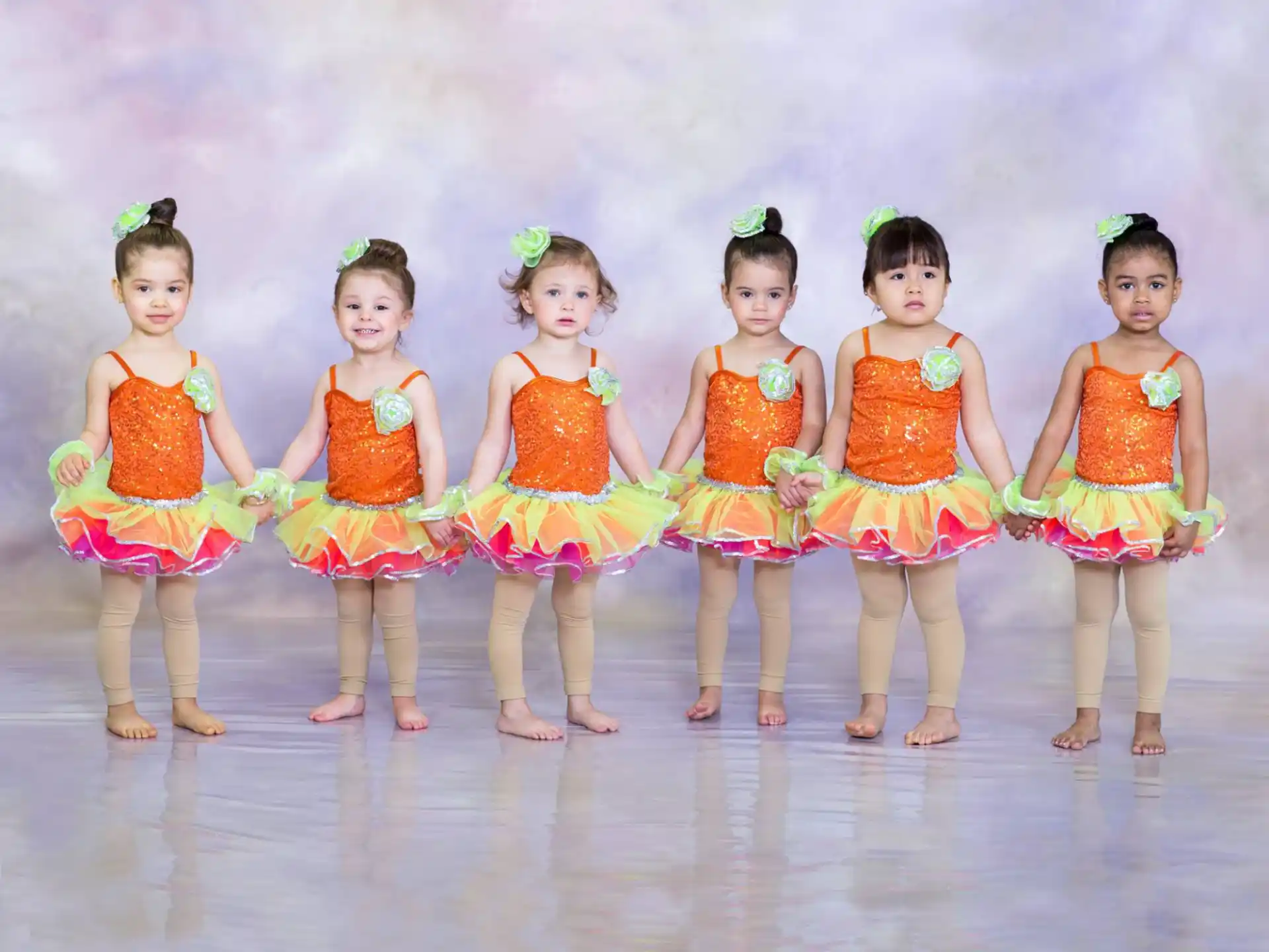 a group of girls in colorful dresses