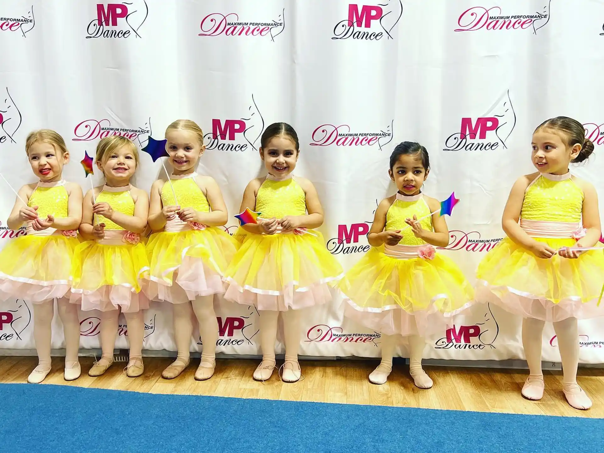 a group of girls in yellow dresses