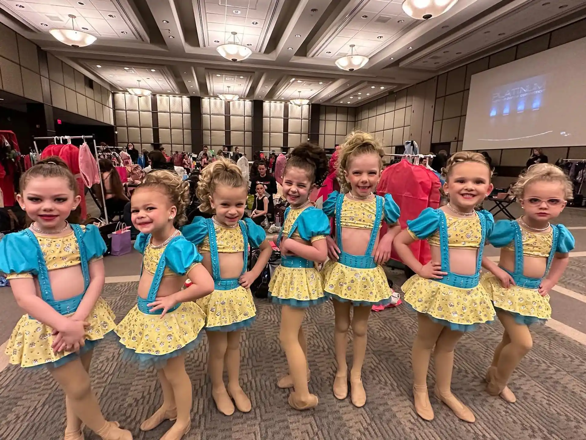 a group of girls in matching outfits
