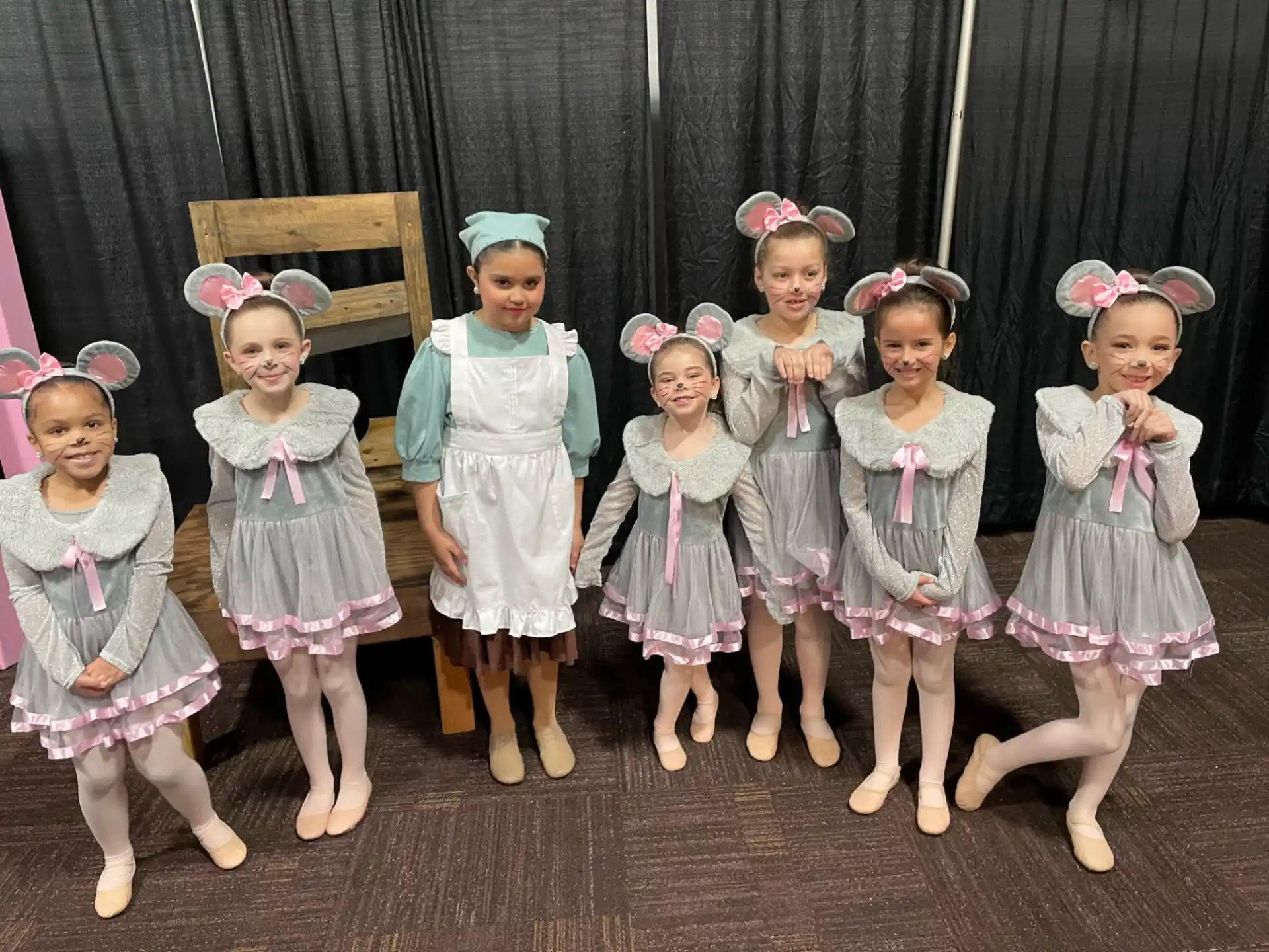 a group of girls in dresses