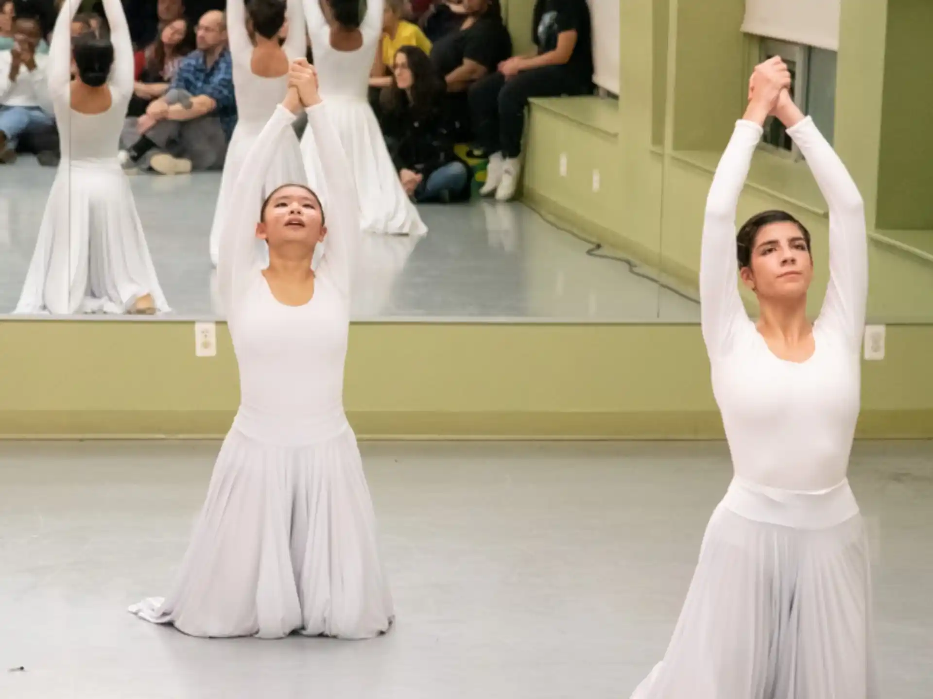 a group of women in white dresses