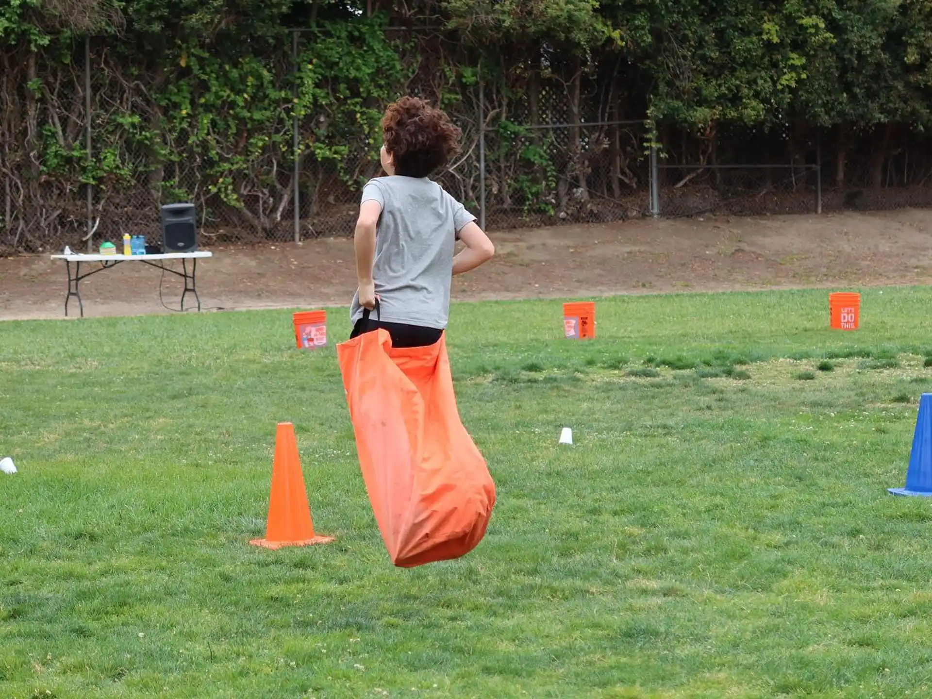 a person holding a red and white flag on a grass field
