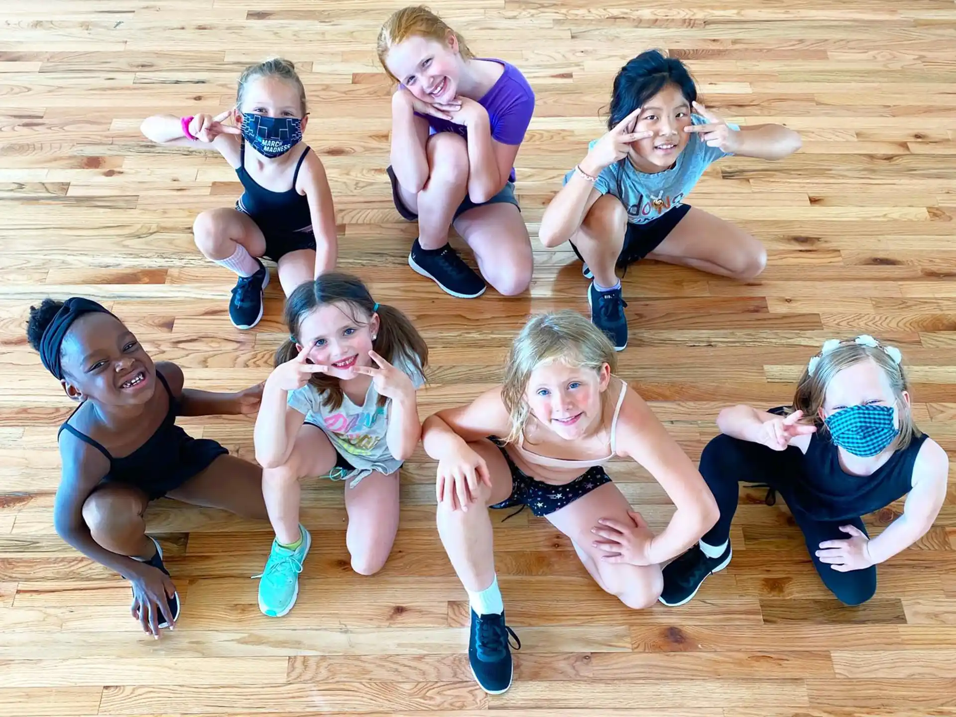 a group of girls wearing swimsuits and posing for a photo