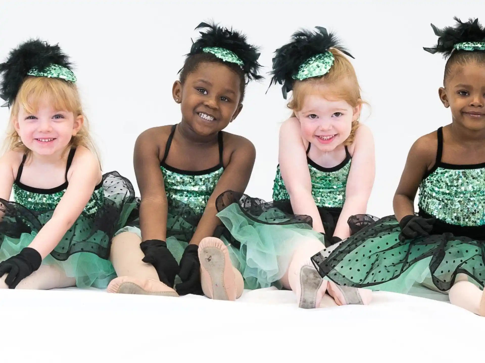 a group of young girls sitting on the floor