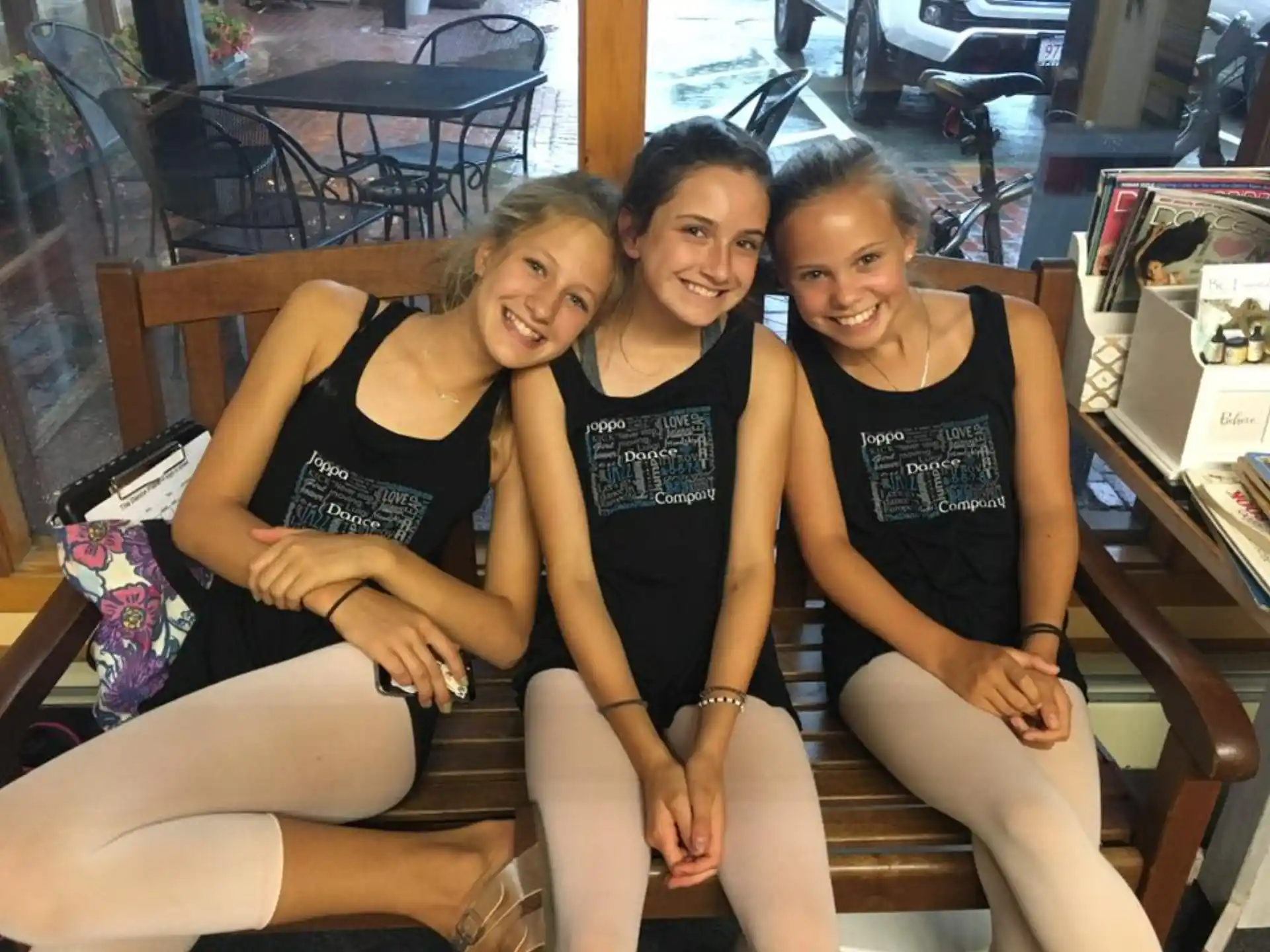 a group of women sitting on a bench